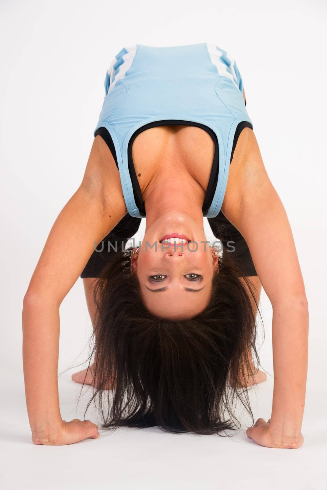 Young adult female prepares to turn herself back over after performing some stretches