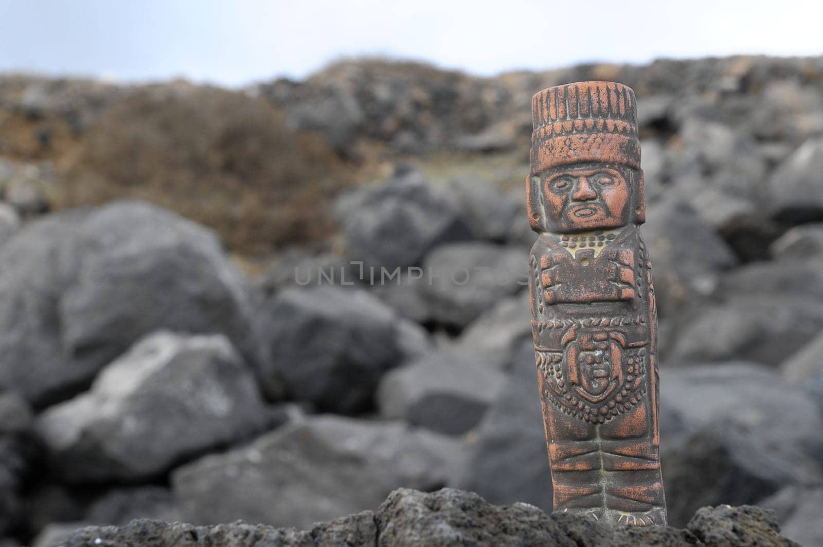 Ancient Maya Statue on the Rocks near the Ocean