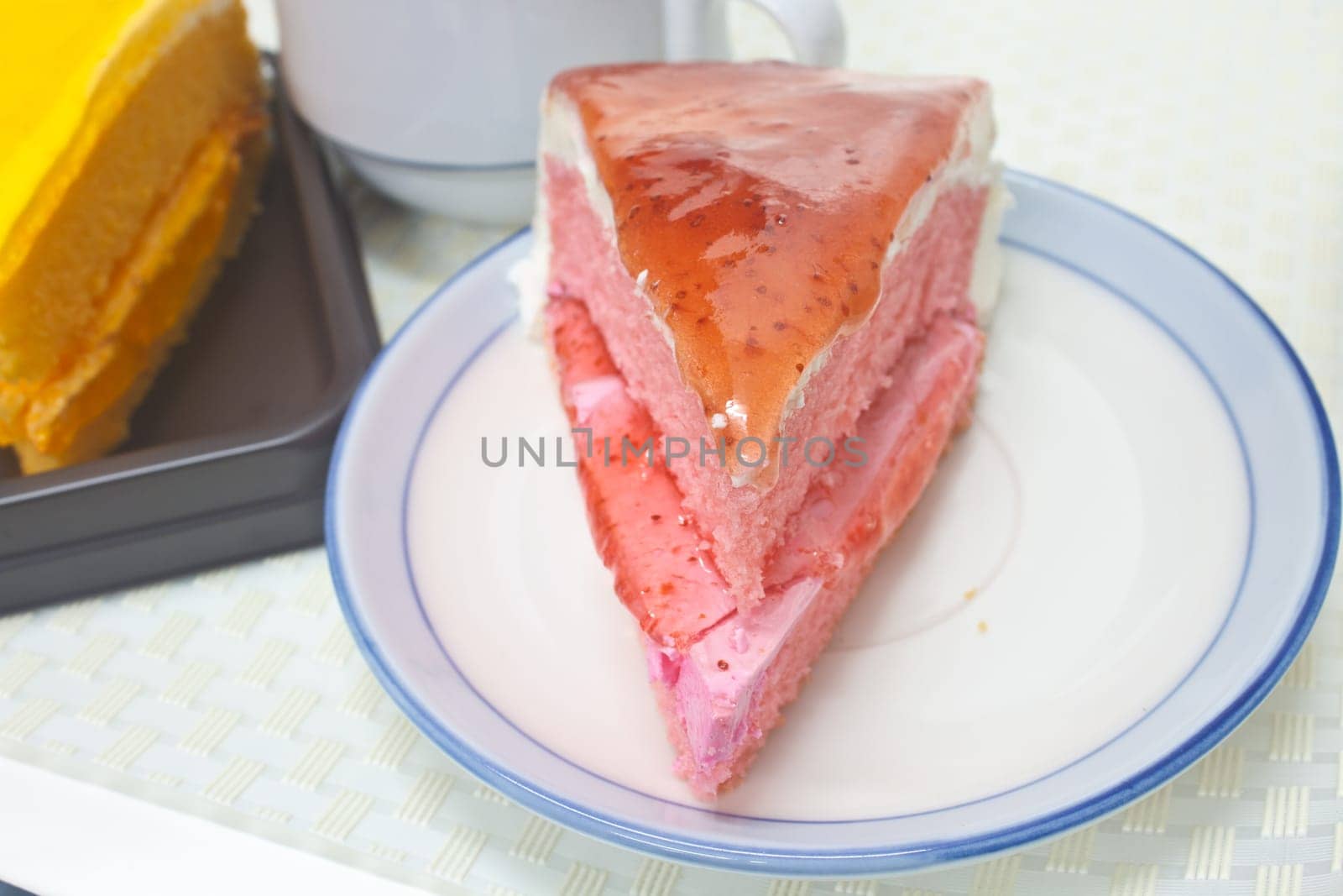 Dessert Orange Cheesecake with Strawberry cheesecake in plate on background
