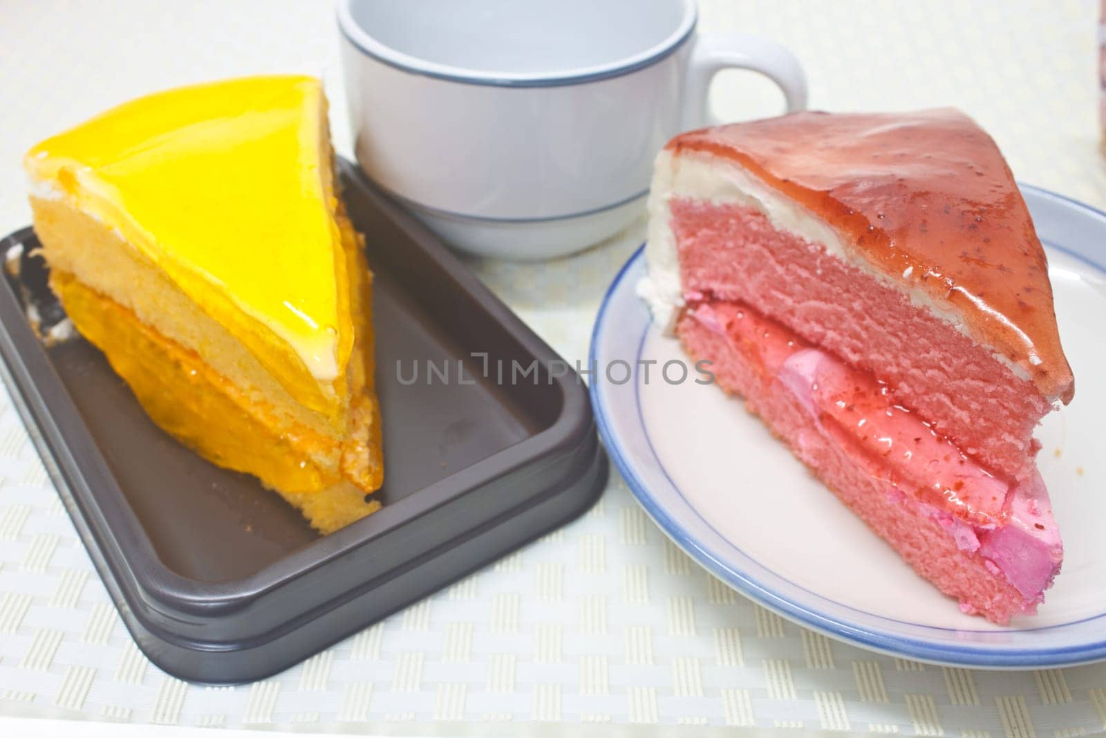 Dessert Orange Cheesecake with Strawberry cheesecake in plate on background