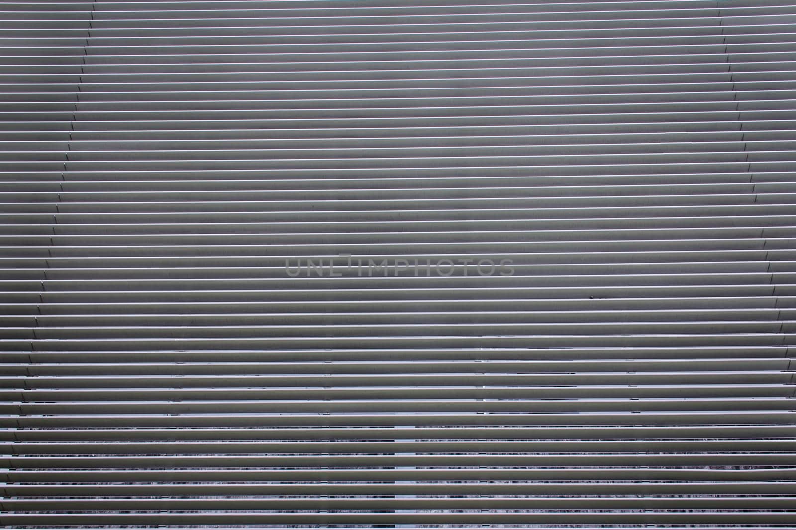 texture of steel ventilation grille on the wall of a building