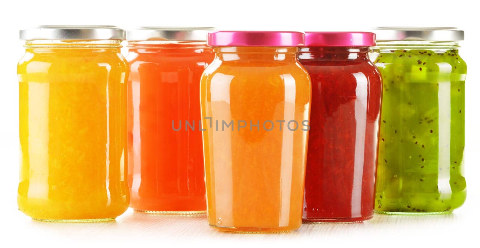 Jars of fruity jams isolated on white background. Preserved fruits