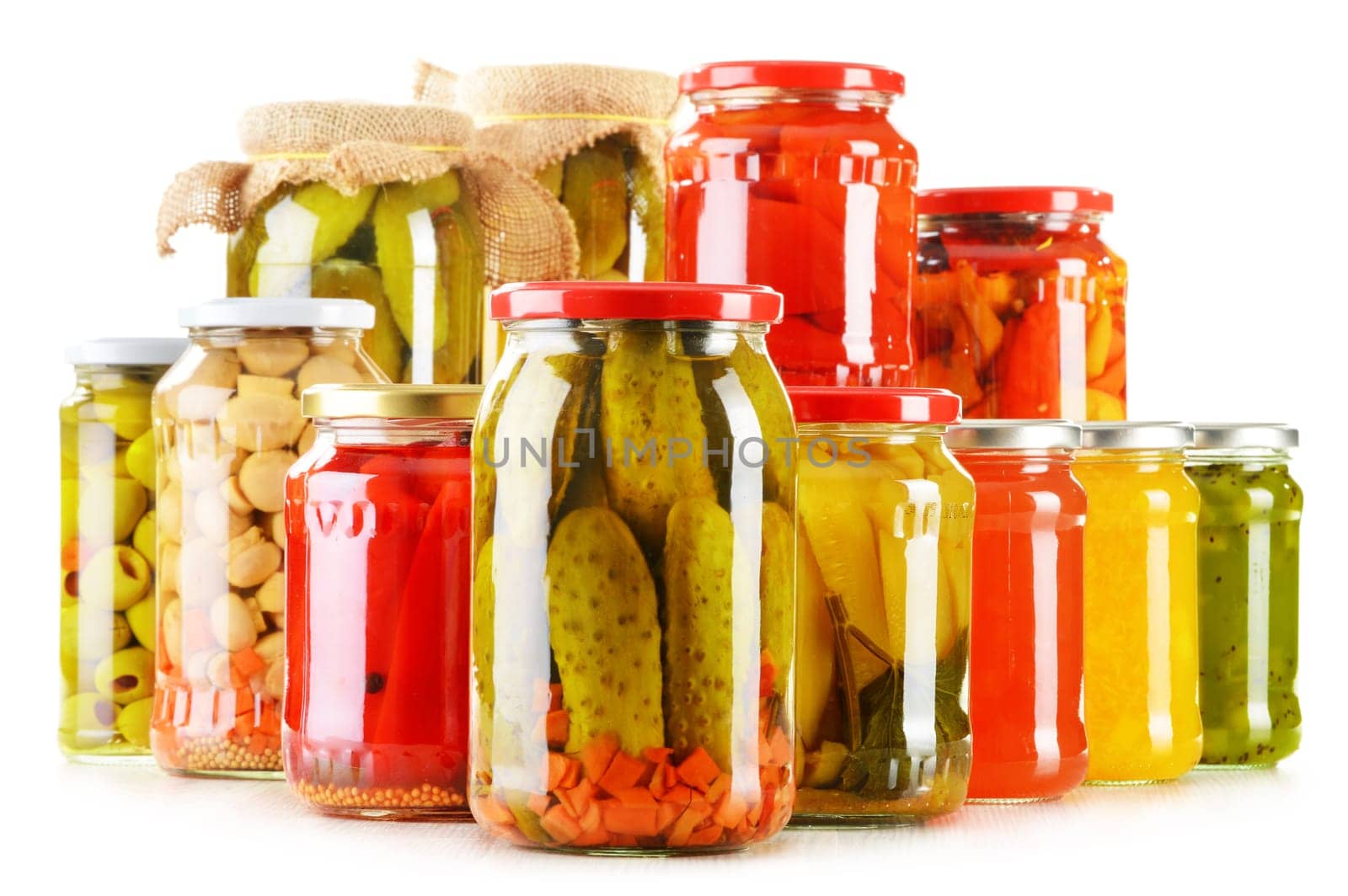Composition with jars of pickled vegetables isolated on white. Marinated food