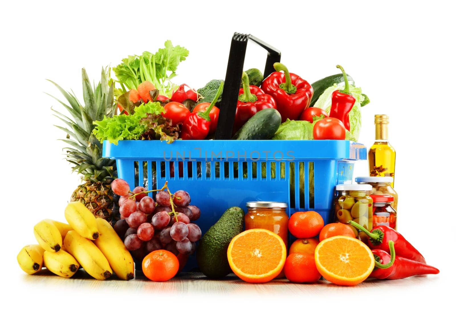 Plastic shopping basket with groceries isolated on white background