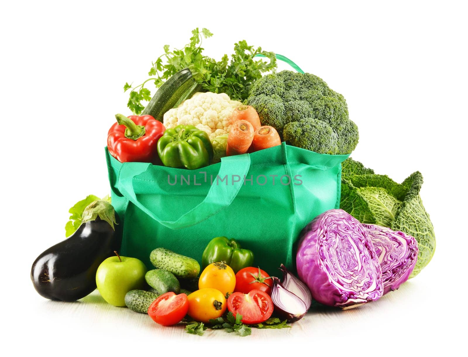 Shopping bag with variety of fresh organic vegetables isolated on white
