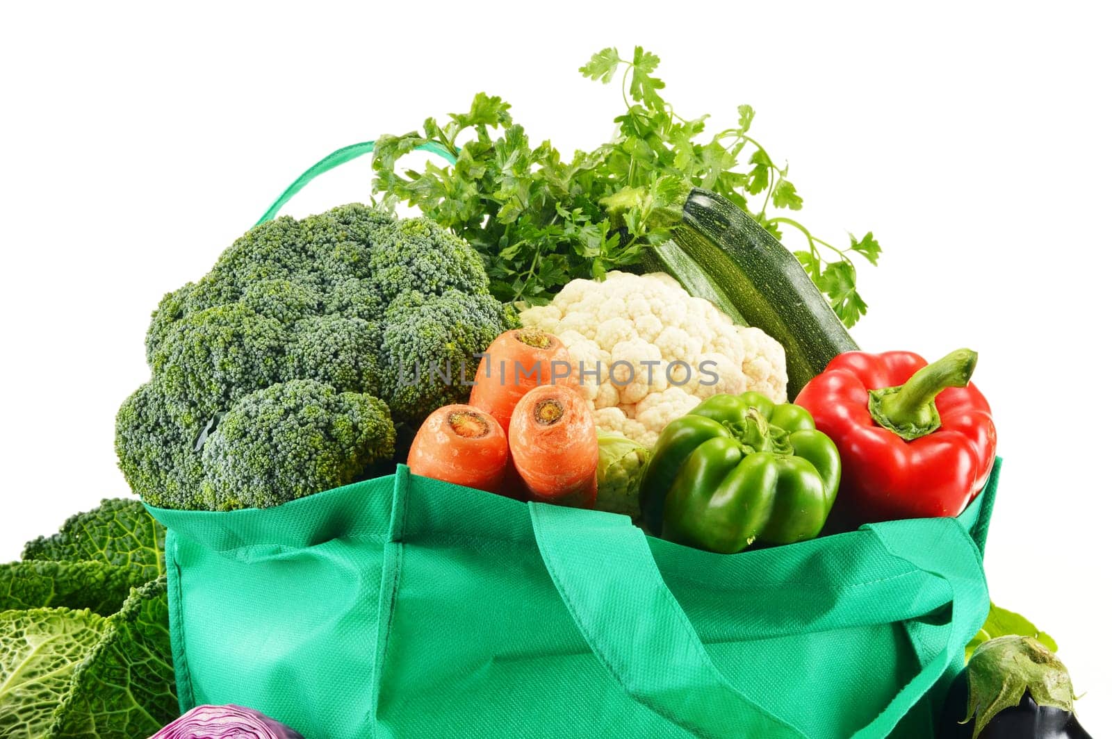 Shopping bag with variety of fresh organic vegetables isolated on white