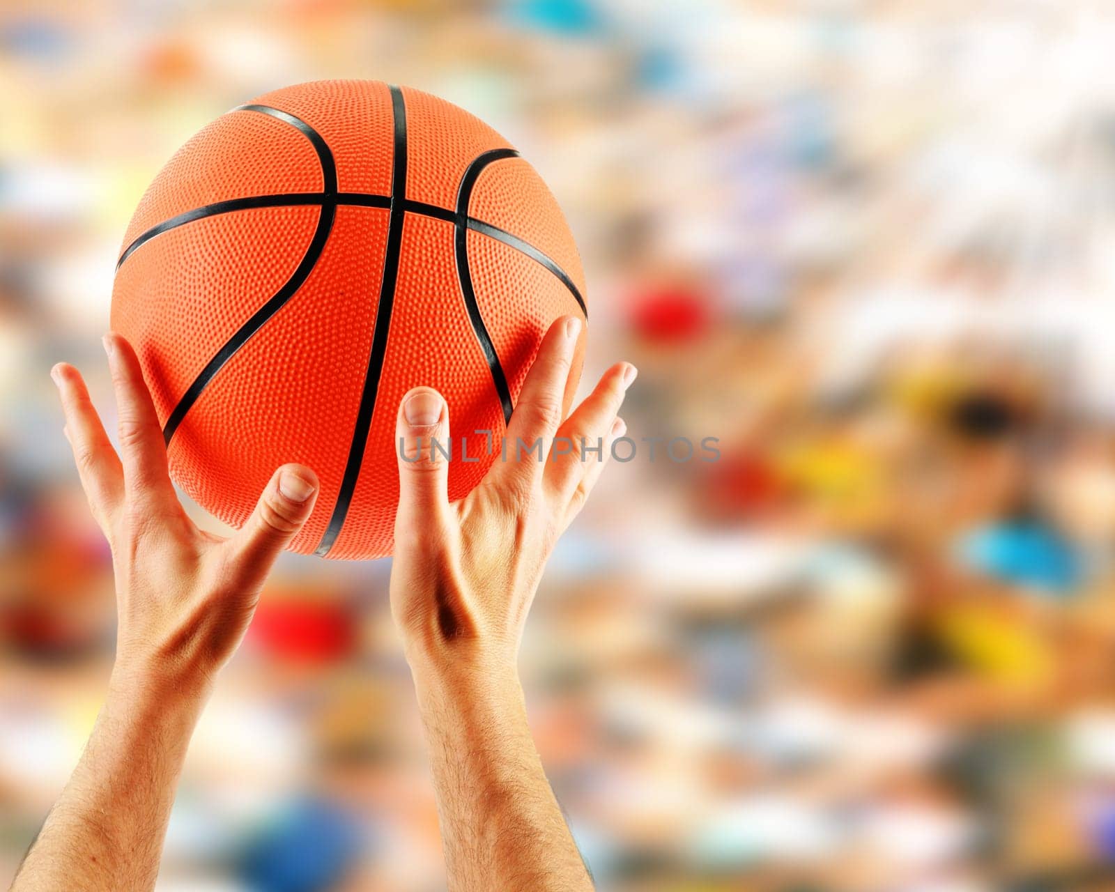 Hands catching basketball