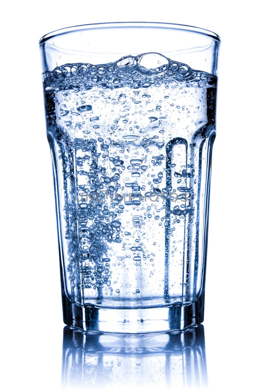 Glass filled with sparkling water. Isolated on white background