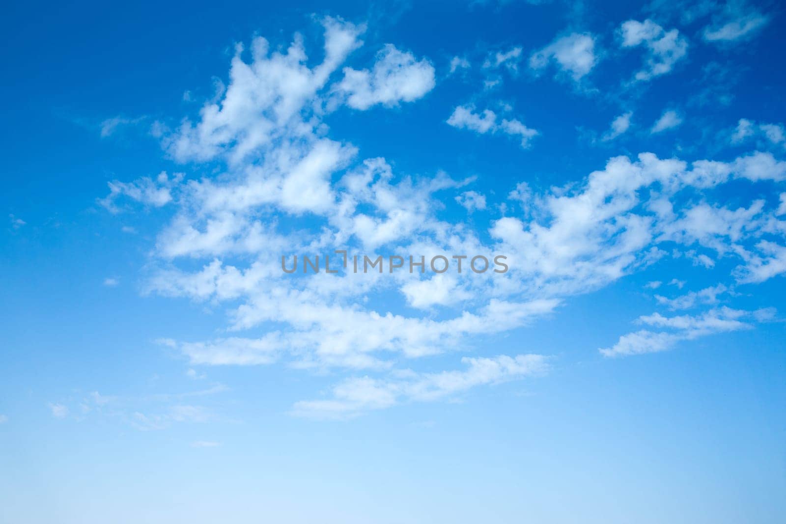 Blue sky background with a tiny clouds