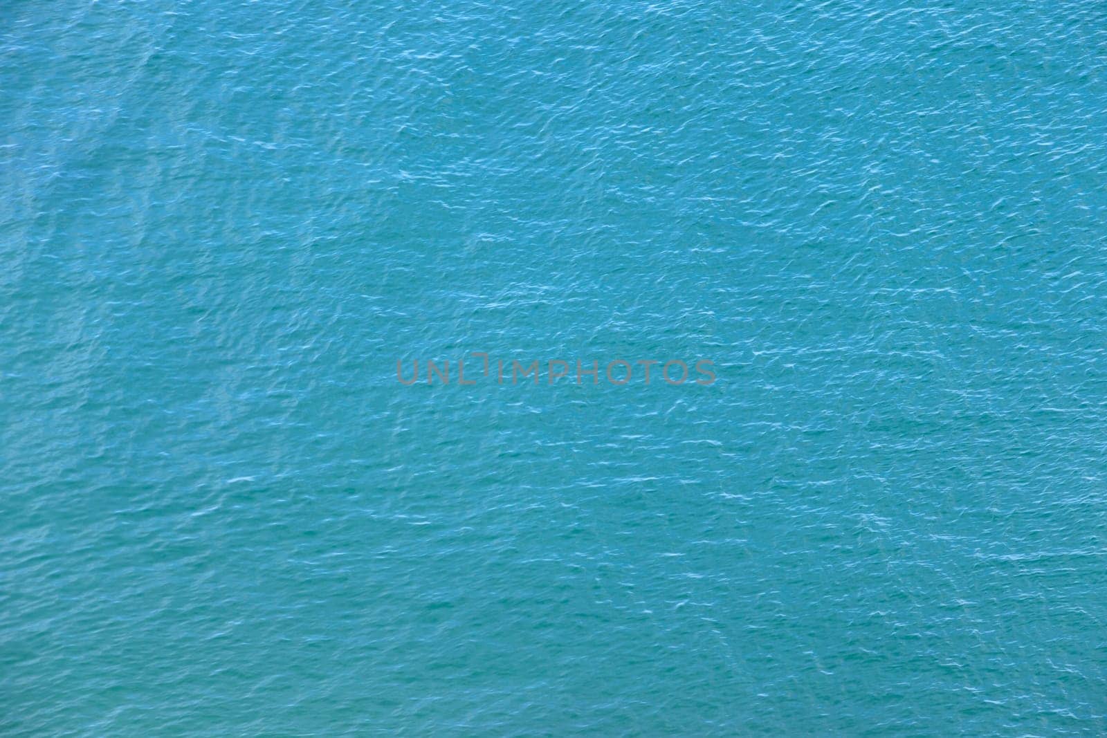 Blue water with sun reflections