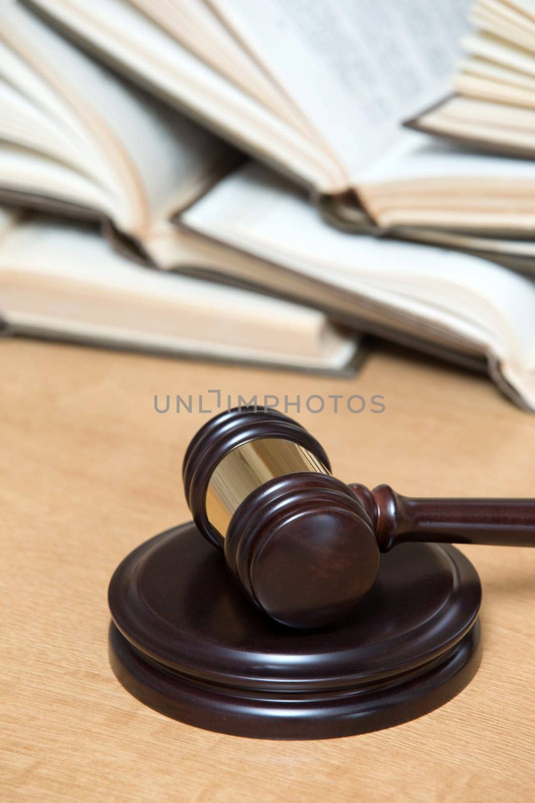 wooden gavel and books on wooden table