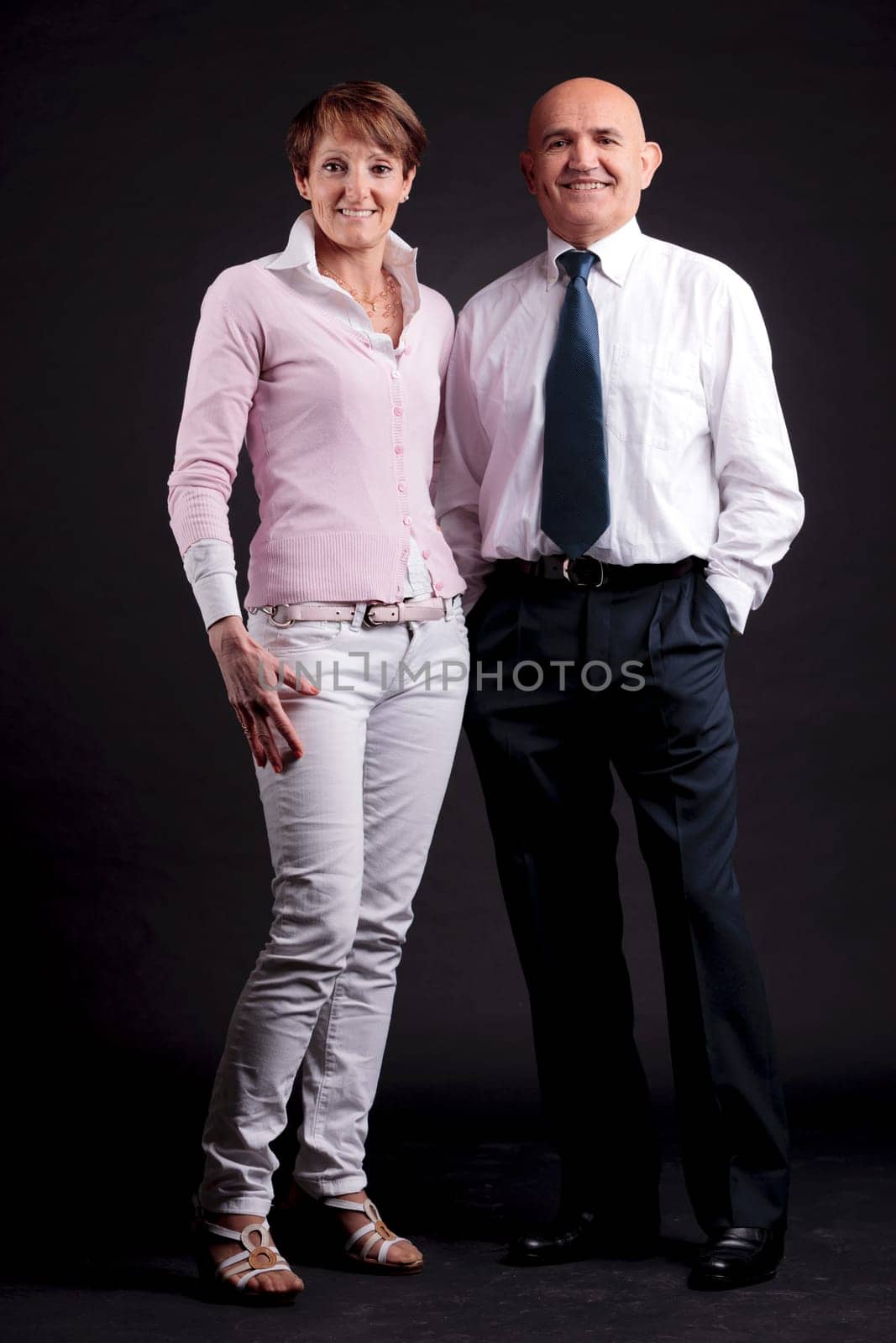 an elderly couple smiling to the camera