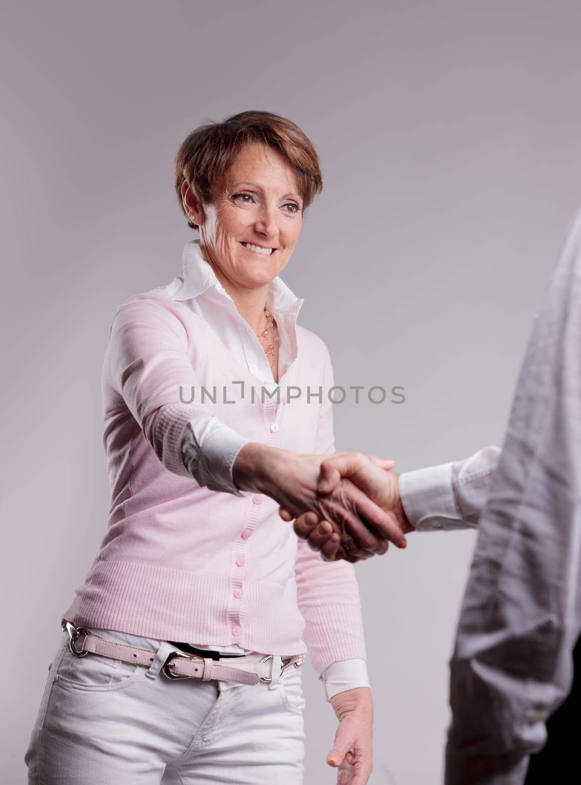 a happy senior woman handshaking