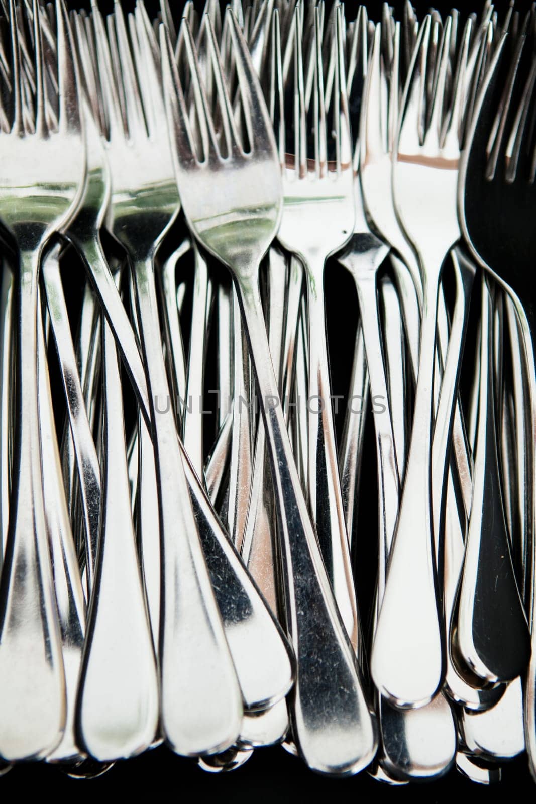 Closeup of bunch of metal silver colored eating forks