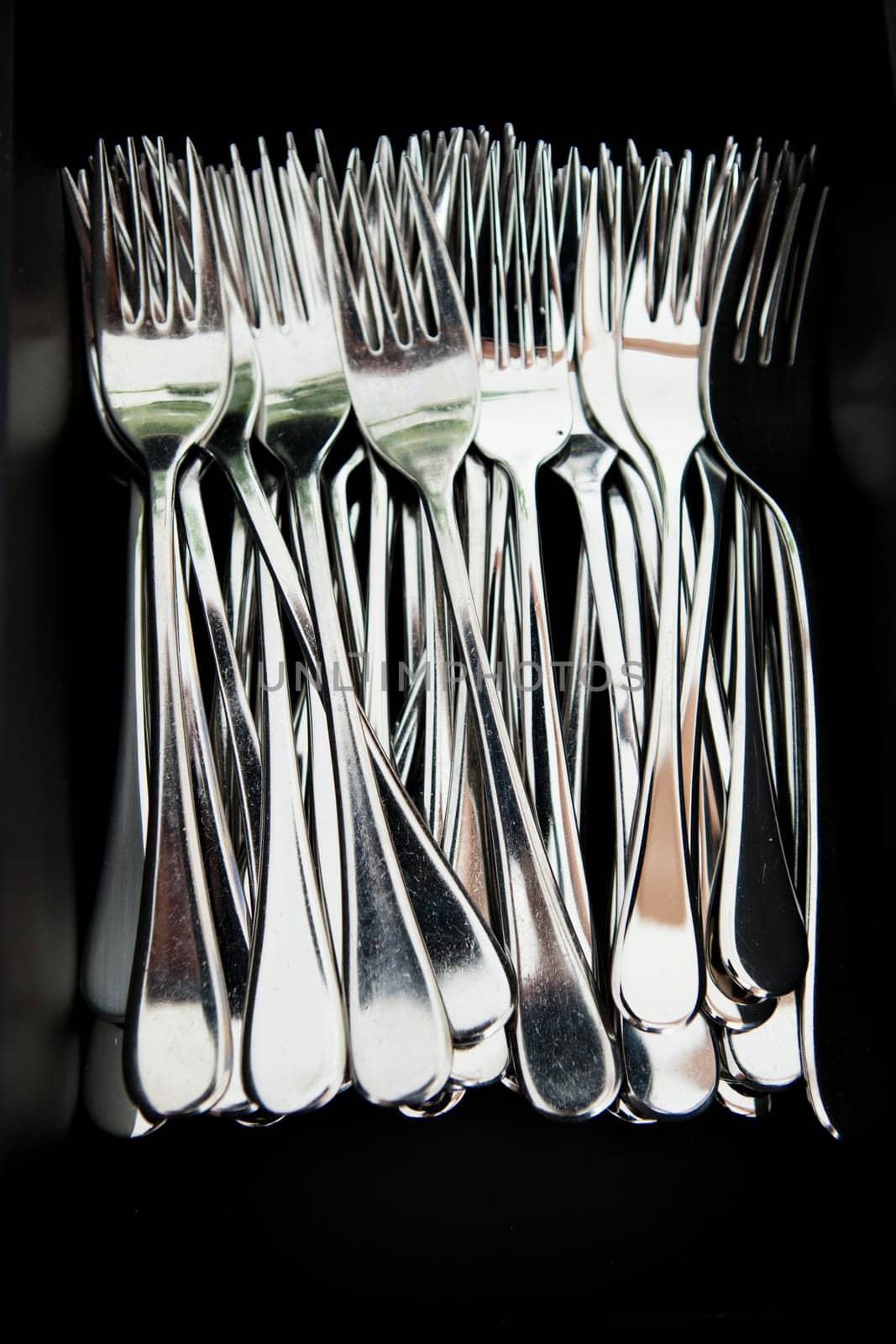 Closeup of bunch of metal silver colored eating forks