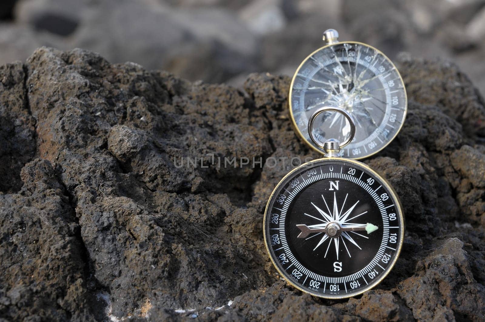 Orientation Concept - Analogic Compass Abandoned on the Rocks