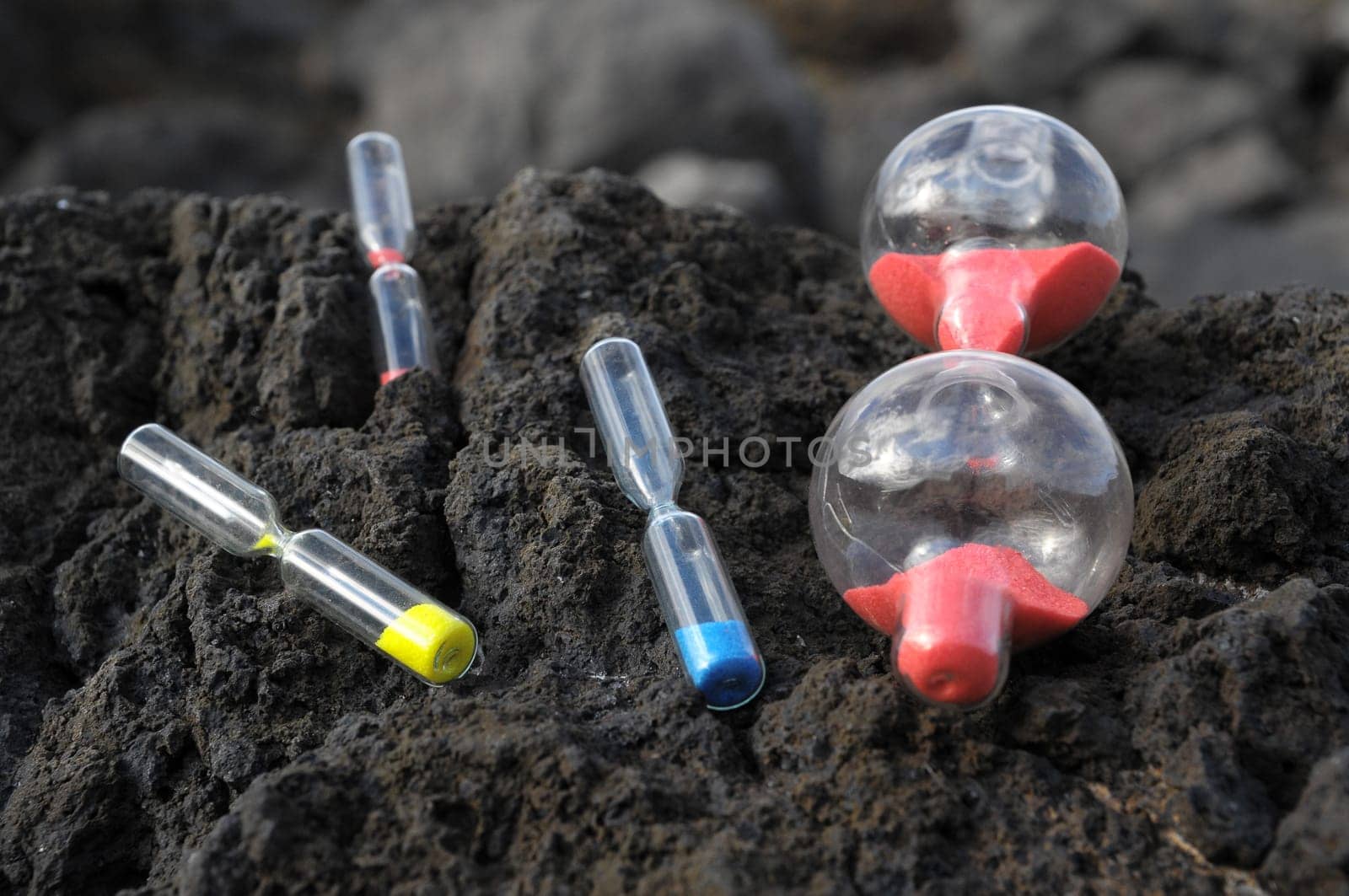 Time Concept - Hourglass Abandoned on the Volcanic Rocks