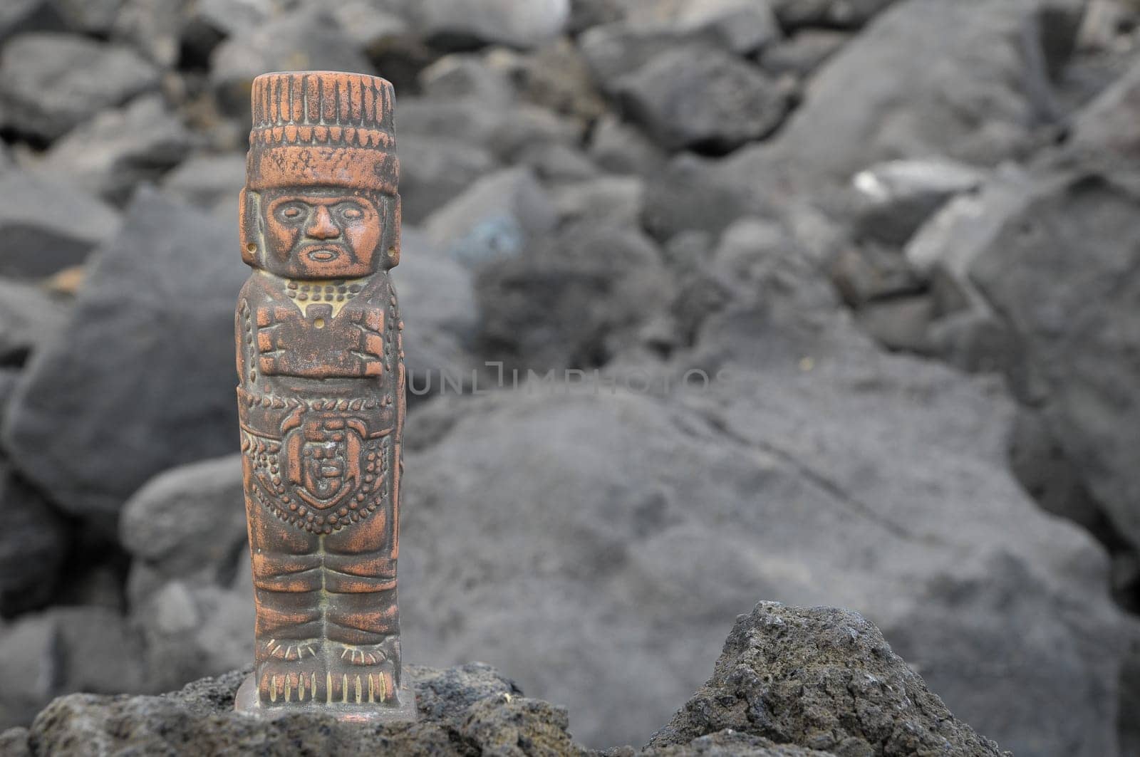 Ancient Maya Statue on the Rocks near Ocean
