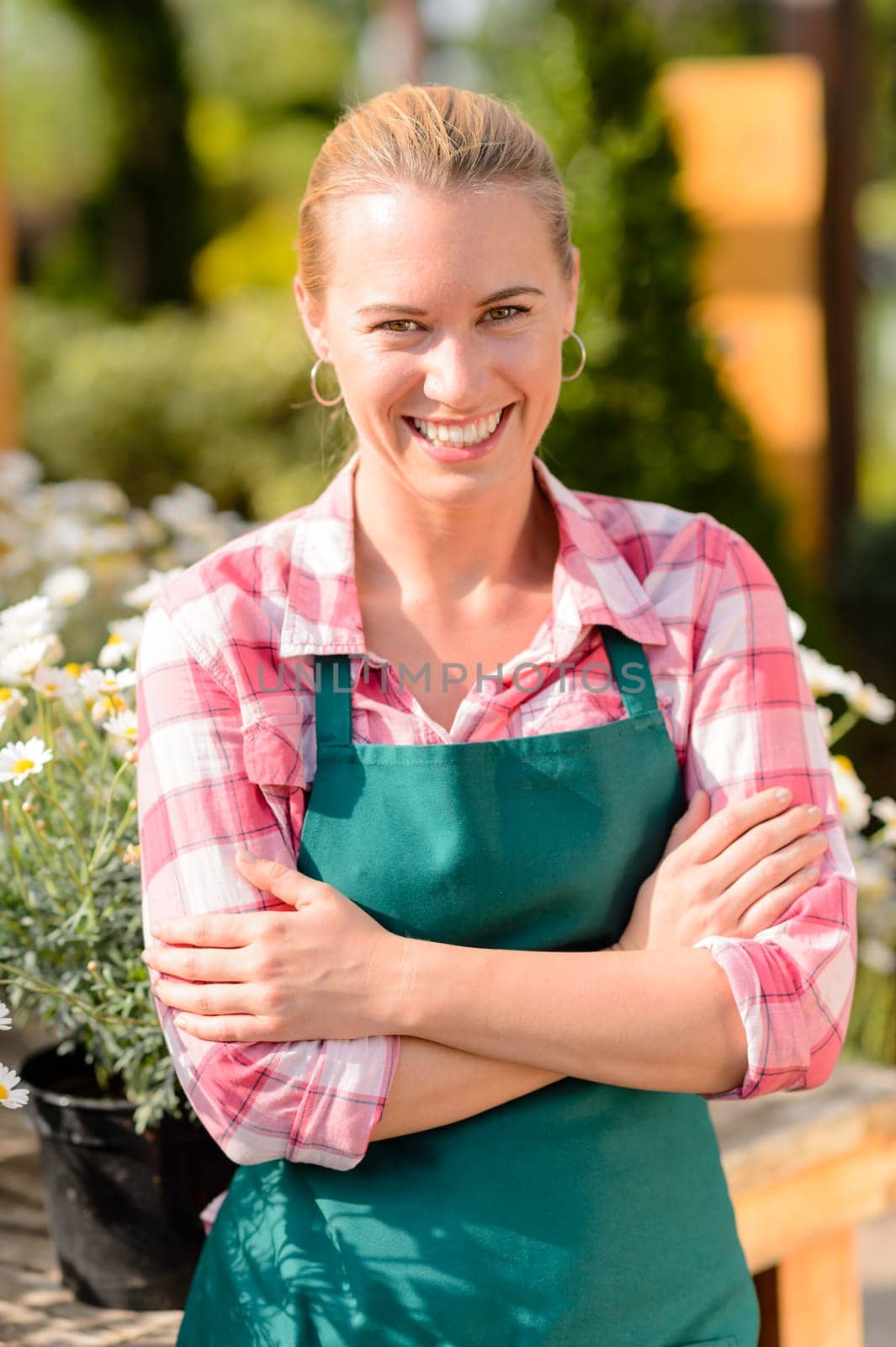 Garden center smiling woman worker wear apron portrait sunny day