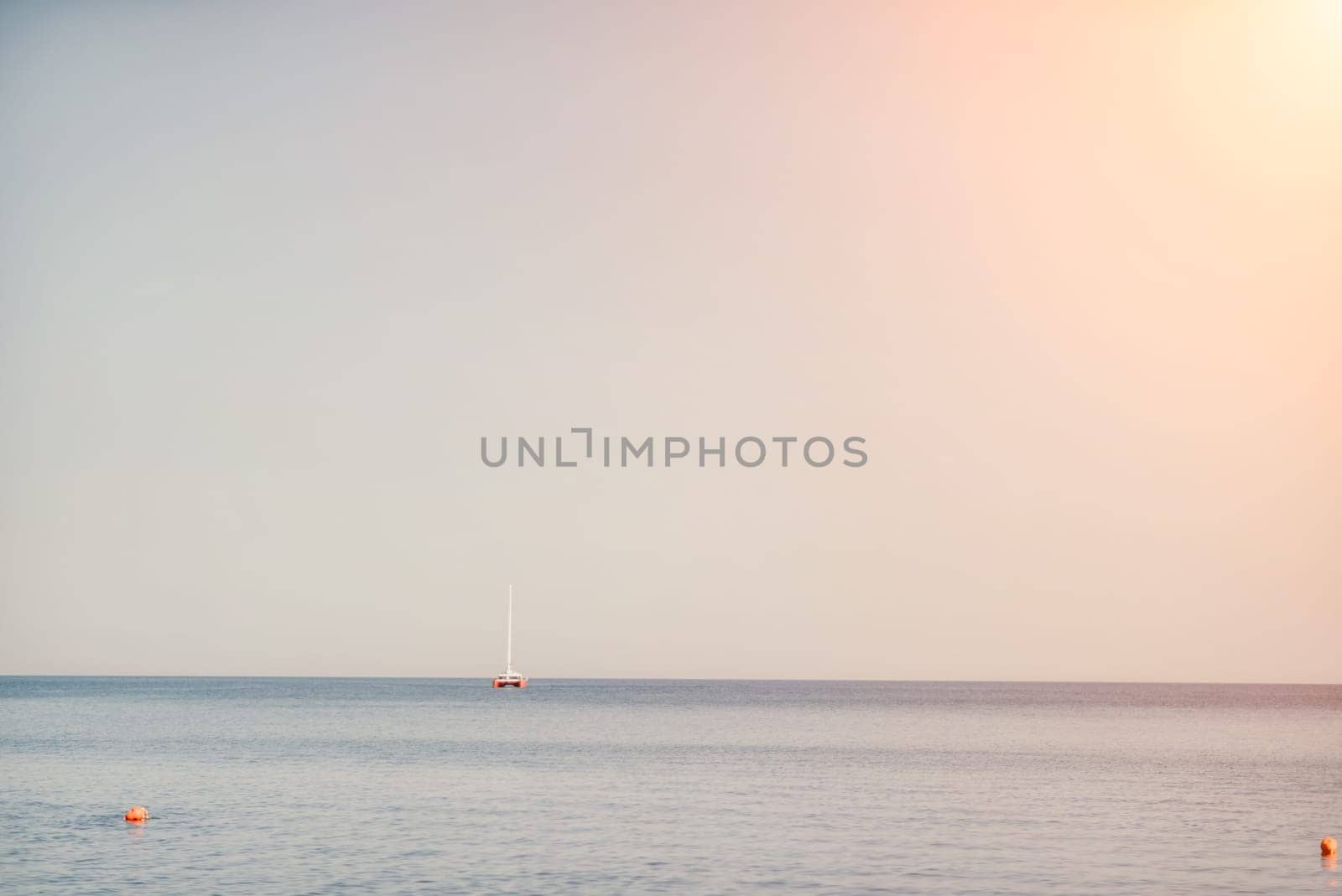 Aerial yacht on calm sea. Luxury cruise trip. View from above of white boat on deep blue water. Aerial view of rich yacht sailing sea. Summer journey on luxury ship. by panophotograph