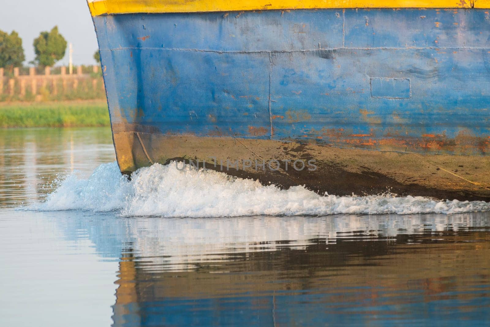 Closeup of bow on industrial river barge boat vessel traveling along large river in Africa 