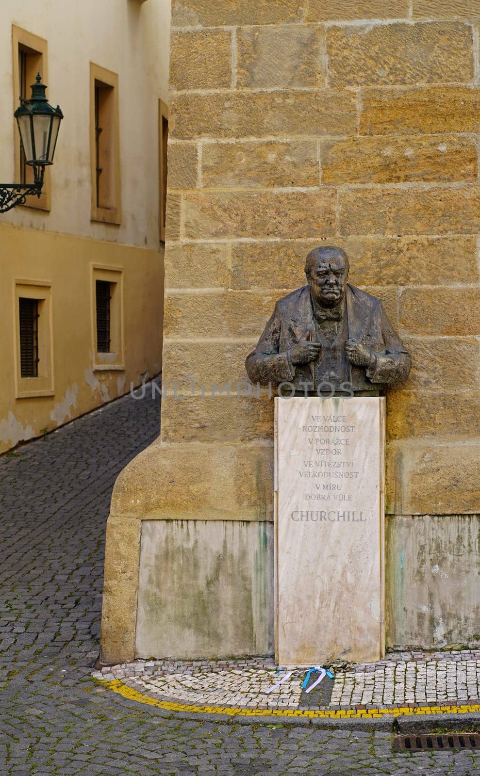 PRAGUE, CZECH REPUBLIC - OCTOBER 2023: Bust of Winston Churchill next to the British Embassy. Inscription: In war, there is decisiveness. In defeat, disobedience. There is generosity in victory. by aprilphoto