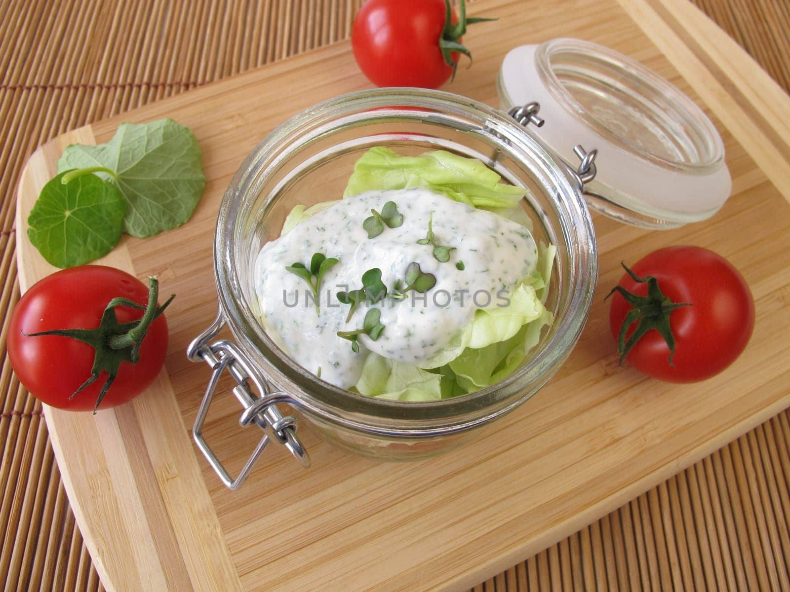 Salad in glass with yoghurt dressing and broccoli sprouts