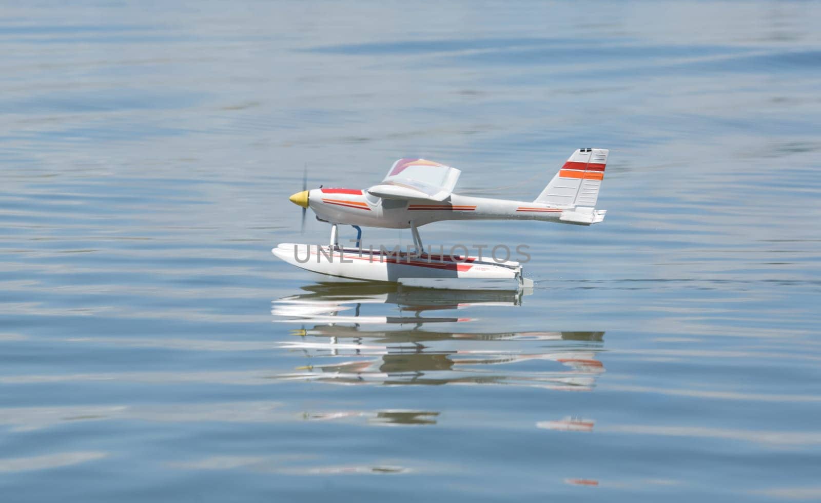 Radio controlled Hydroplane flying and sailing over the Guadiana river surface, Badajoz, Spain