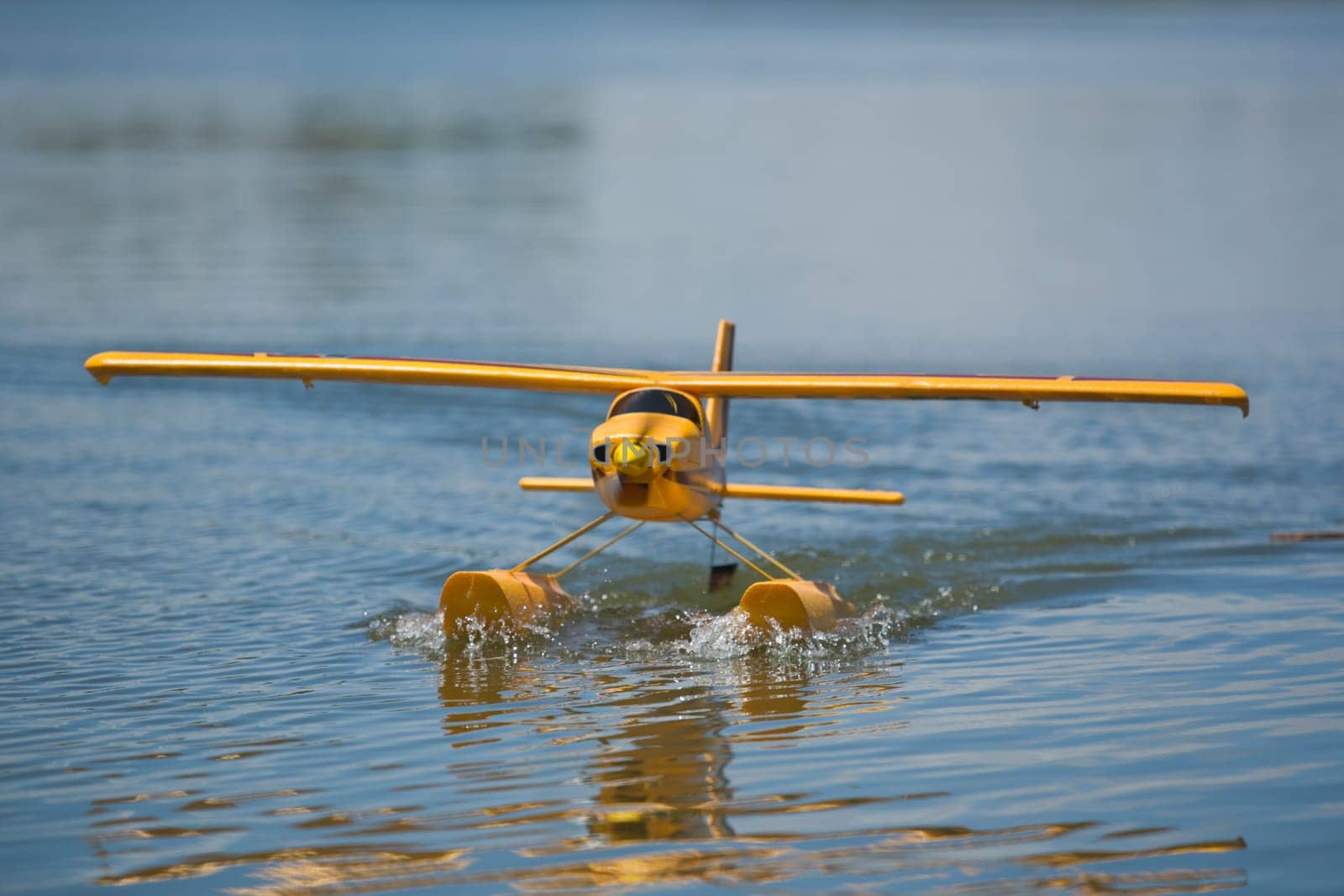 Radio controlled Hydroplane flying and sailing over the Guadiana river surface, Badajoz, Spain