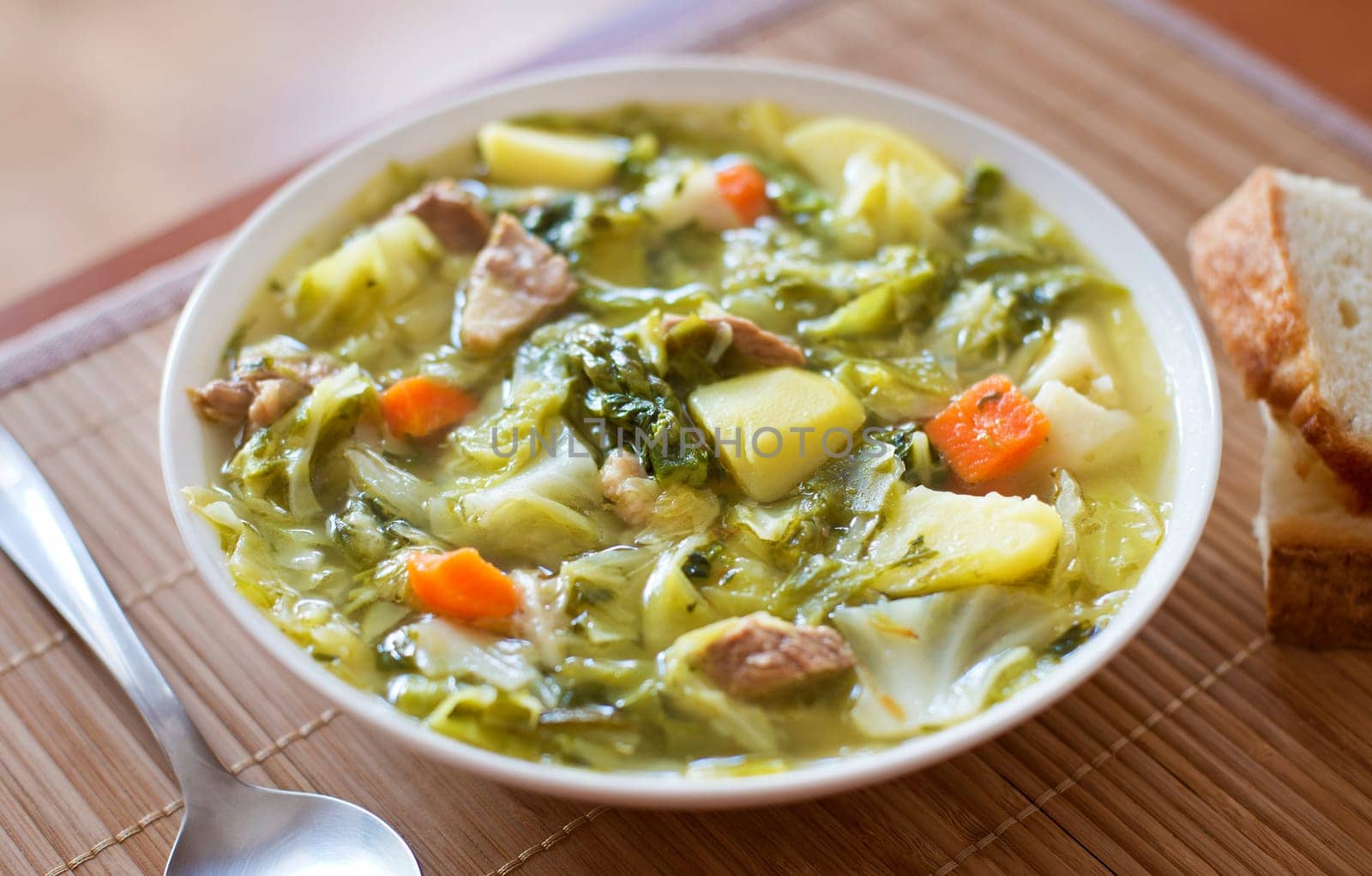 Cabbage soup with meat and potatoes close up