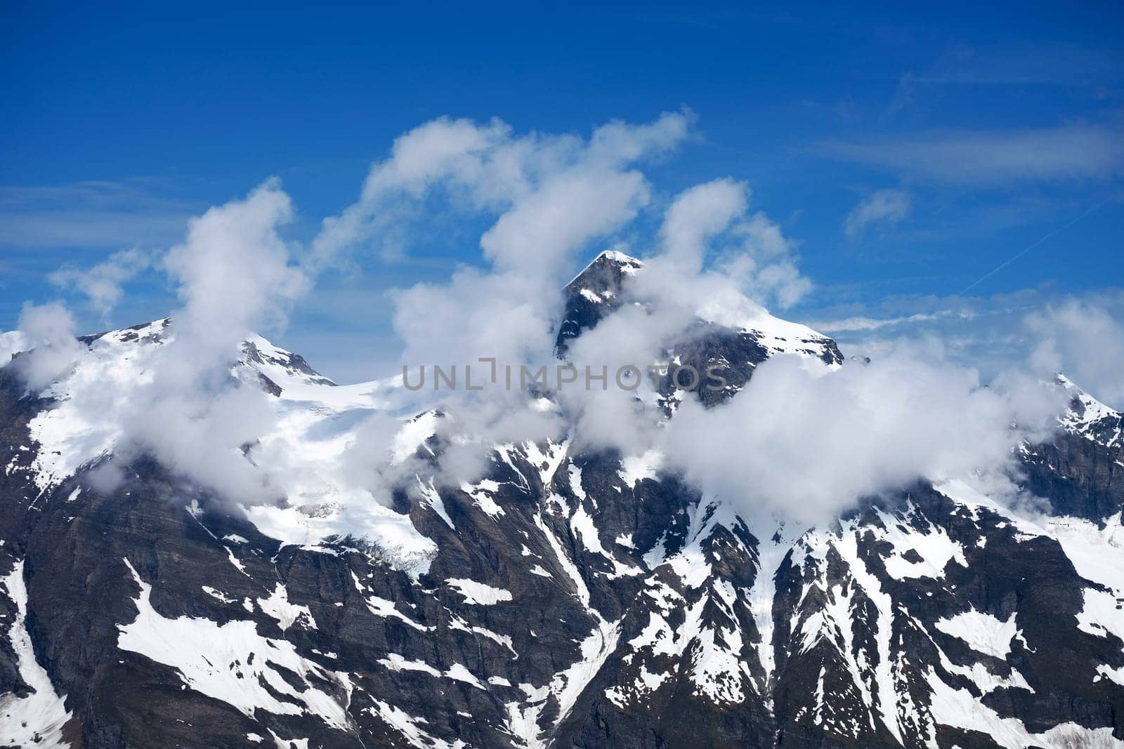 Alps Austria,summit of the Wiesbachhorn with clouds in the Hohe Tauern