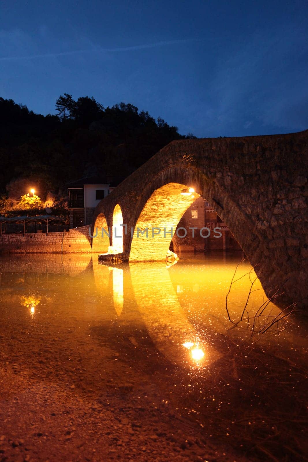 The landscape with the stone bridge on the shores of Lake Skadar or Skadarsko Jezero ini Rijeka Crnojevica in Montenegro in Europe.