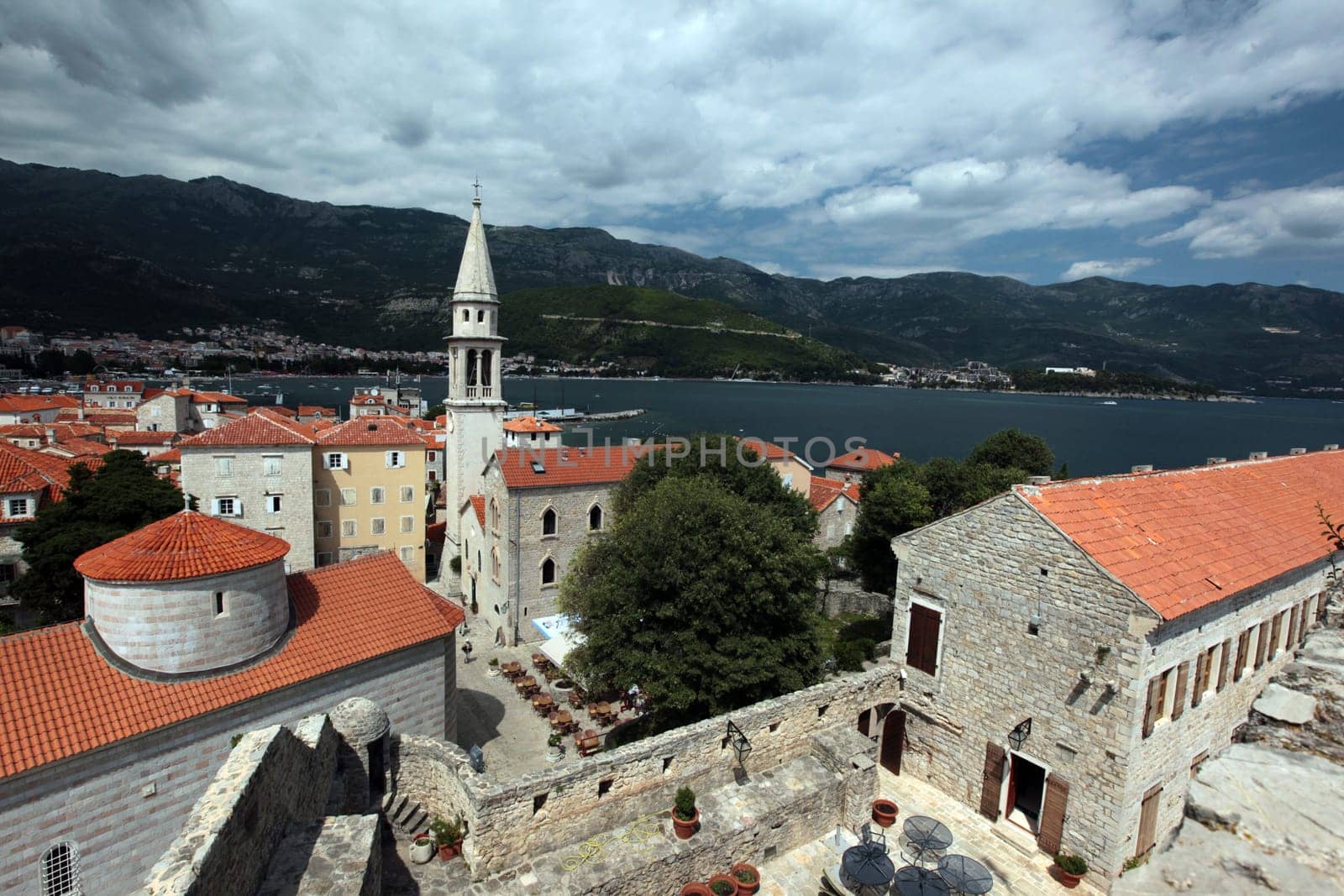 The old town with the church Of Sv. Ivan Krstitelji of the Adriatic city of Budva with many new apartments in Montenegro in the Balkans on the Mediterranean Sea in Europe.