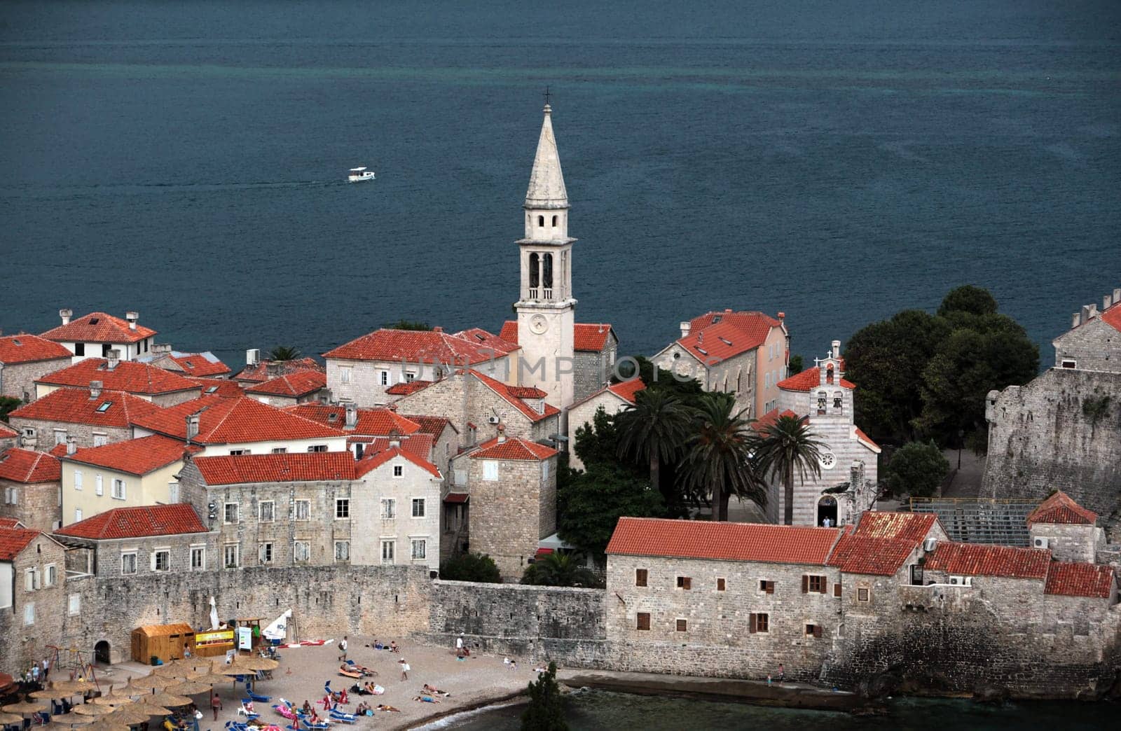 The old town with the church Of Sv. Ivan Krstitelji of the Adriatic city of Budva with many new apartments in Montenegro in the Balkans on the Mediterranean Sea in Europe.