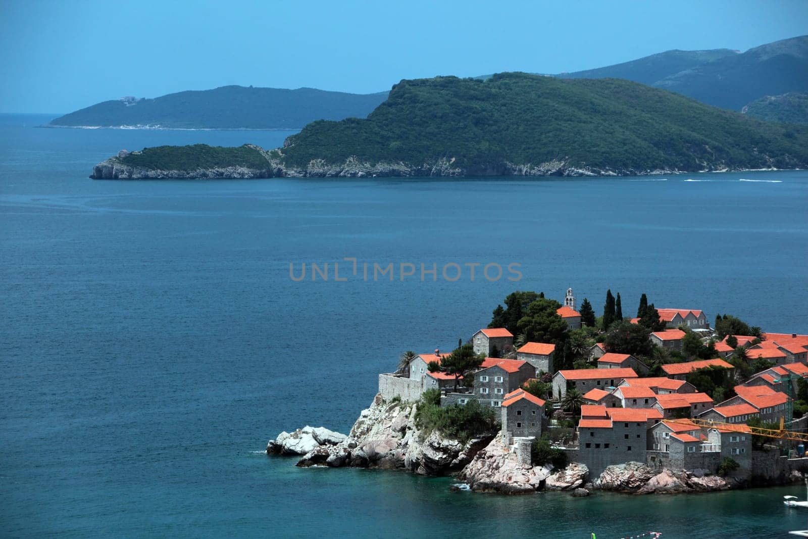 The old town island of Sveti Stefan in the Adriatic Sea on the coast in Montenegro in the Balkans on the Mediterranean Sea in Europe.