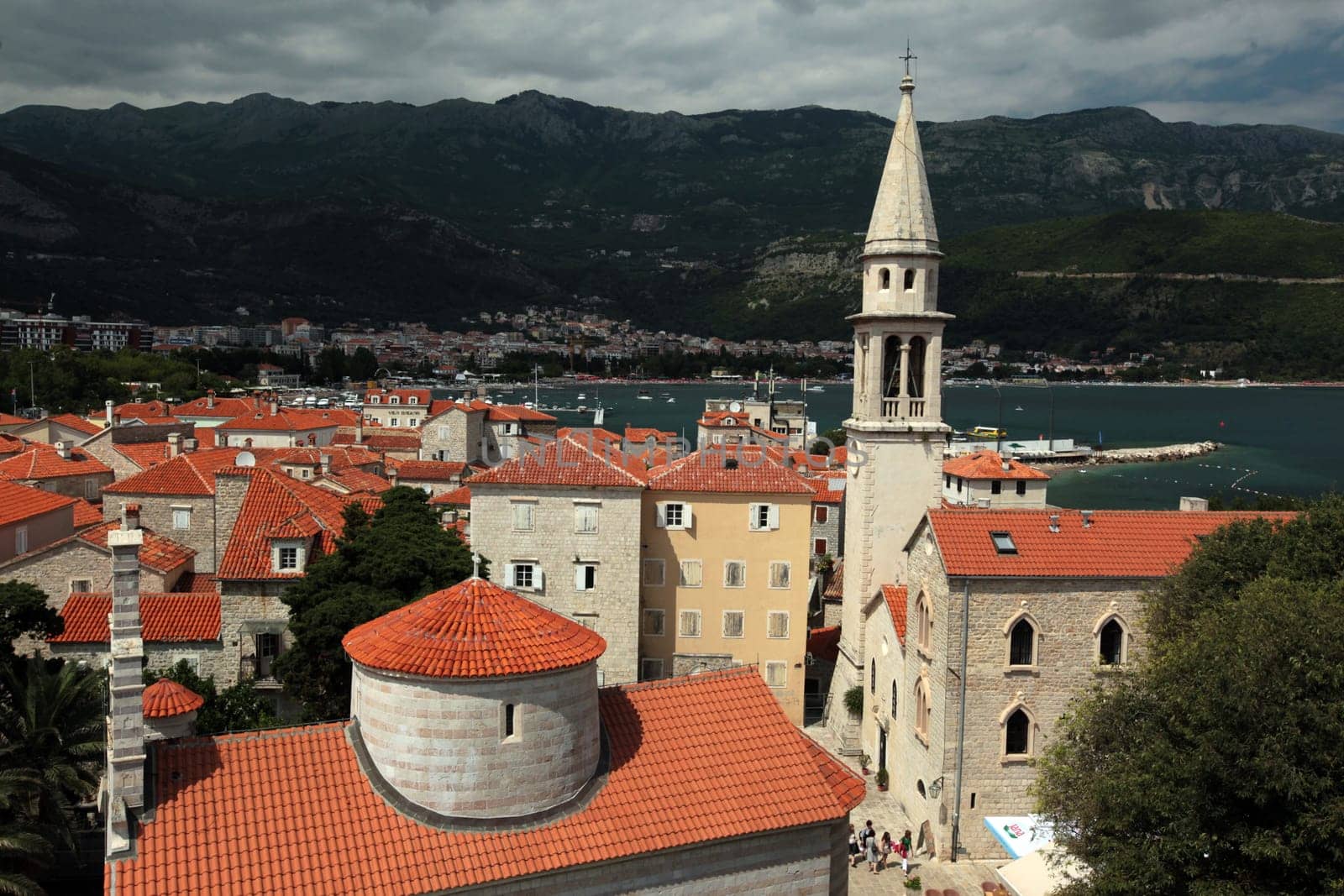 The old town with the church Of Sv. Ivan Krstitelji of the Adriatic city of Budva with many new apartments in Montenegro in the Balkans on the Mediterranean Sea in Europe.