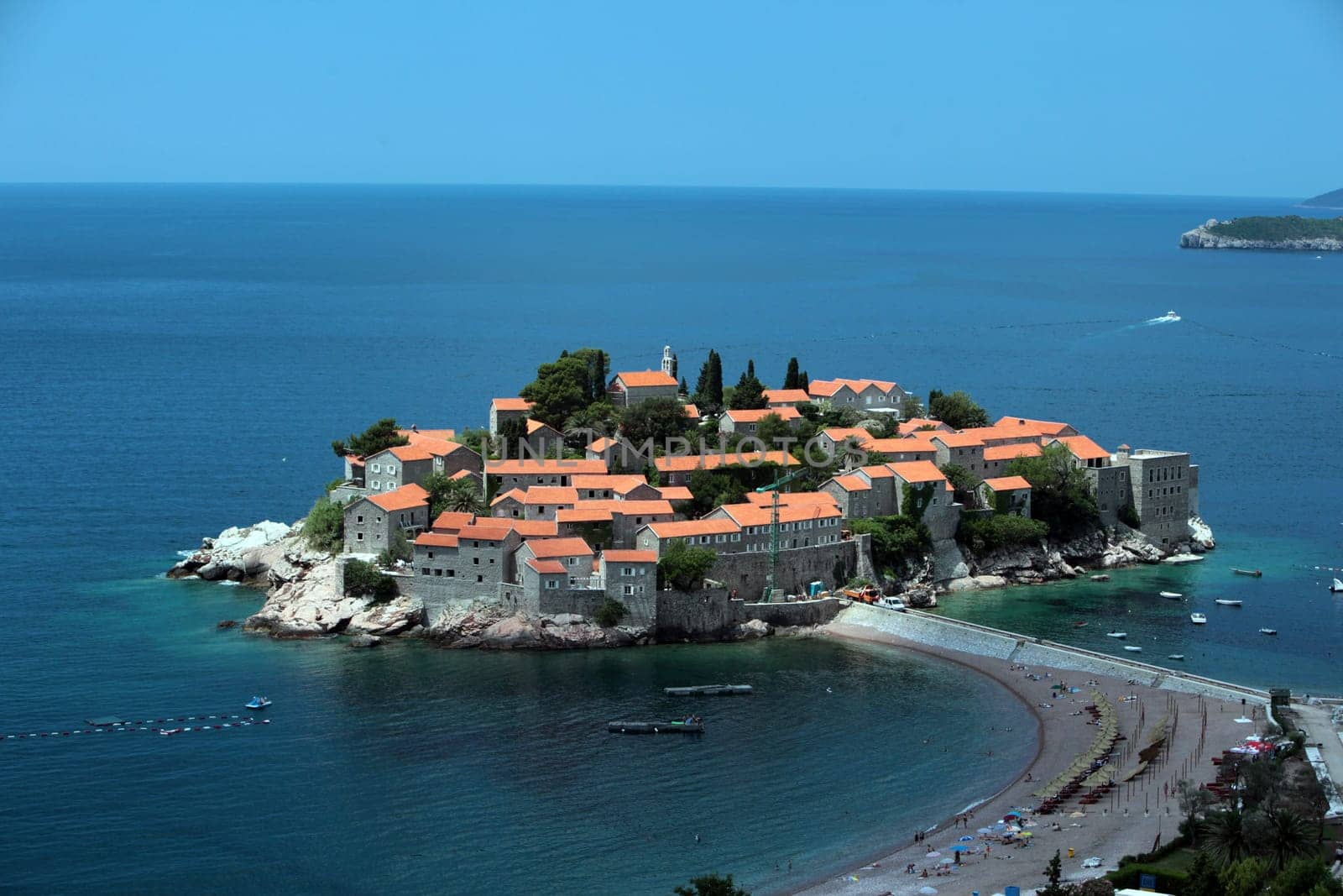 The old town island of Sveti Stefan in the Adriatic Sea on the coast in Montenegro in the Balkans on the Mediterranean Sea in Europe.