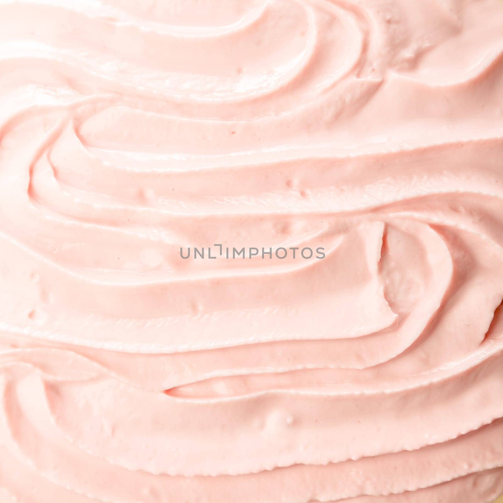 Tasty cold pink berry frozen yoghurt or ice cream background with a smooth creamy texture for a delicious refreshing summer dessert