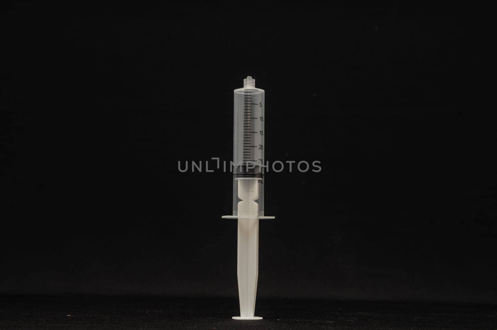 Black and White Syringe on a Dark Background