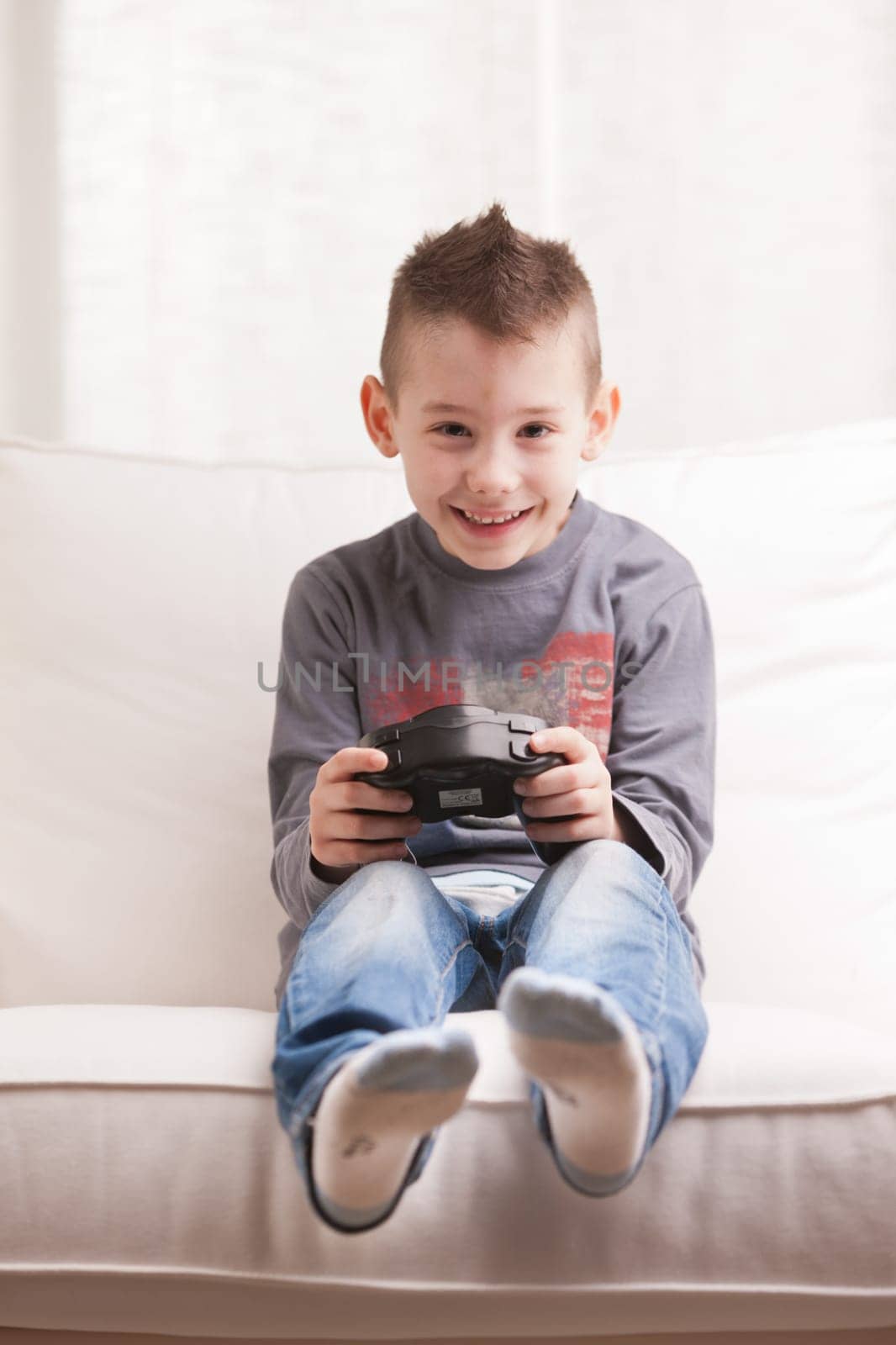Kid having fun with video games in a brighly lit living room
