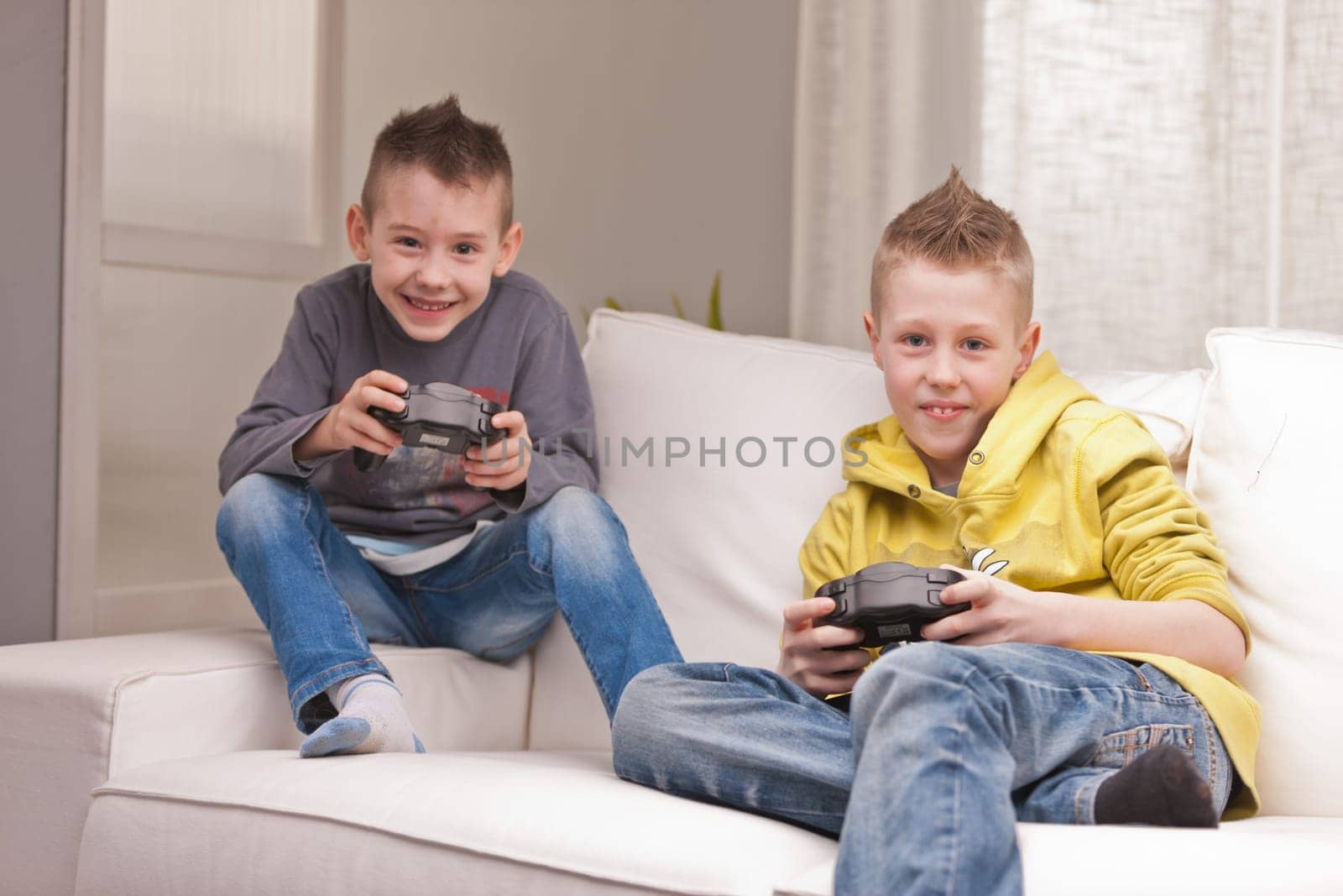 two little boys having lots of fun with video games