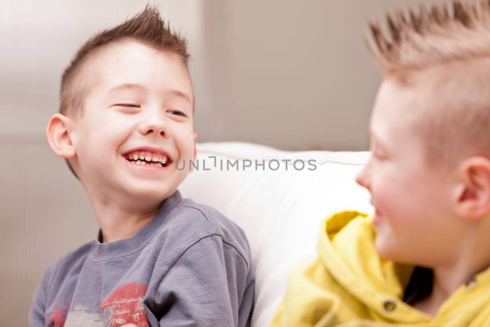 two little boys having lots of fun with video games
