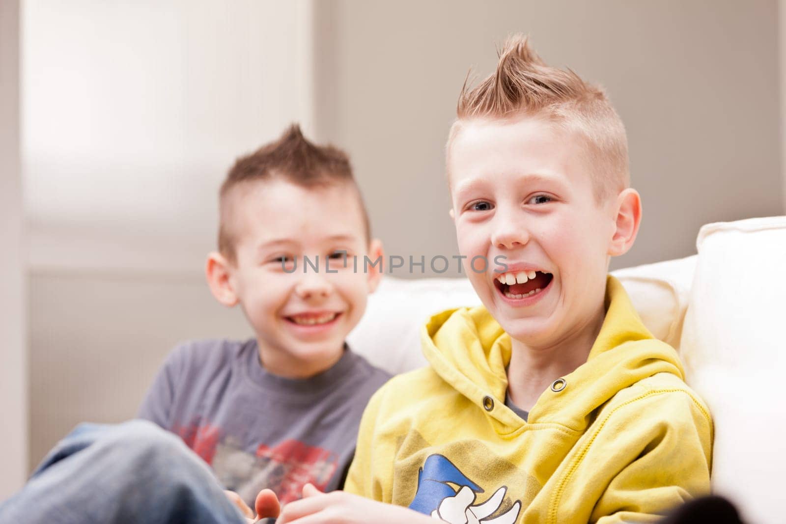 two little boys having lots of fun with video games