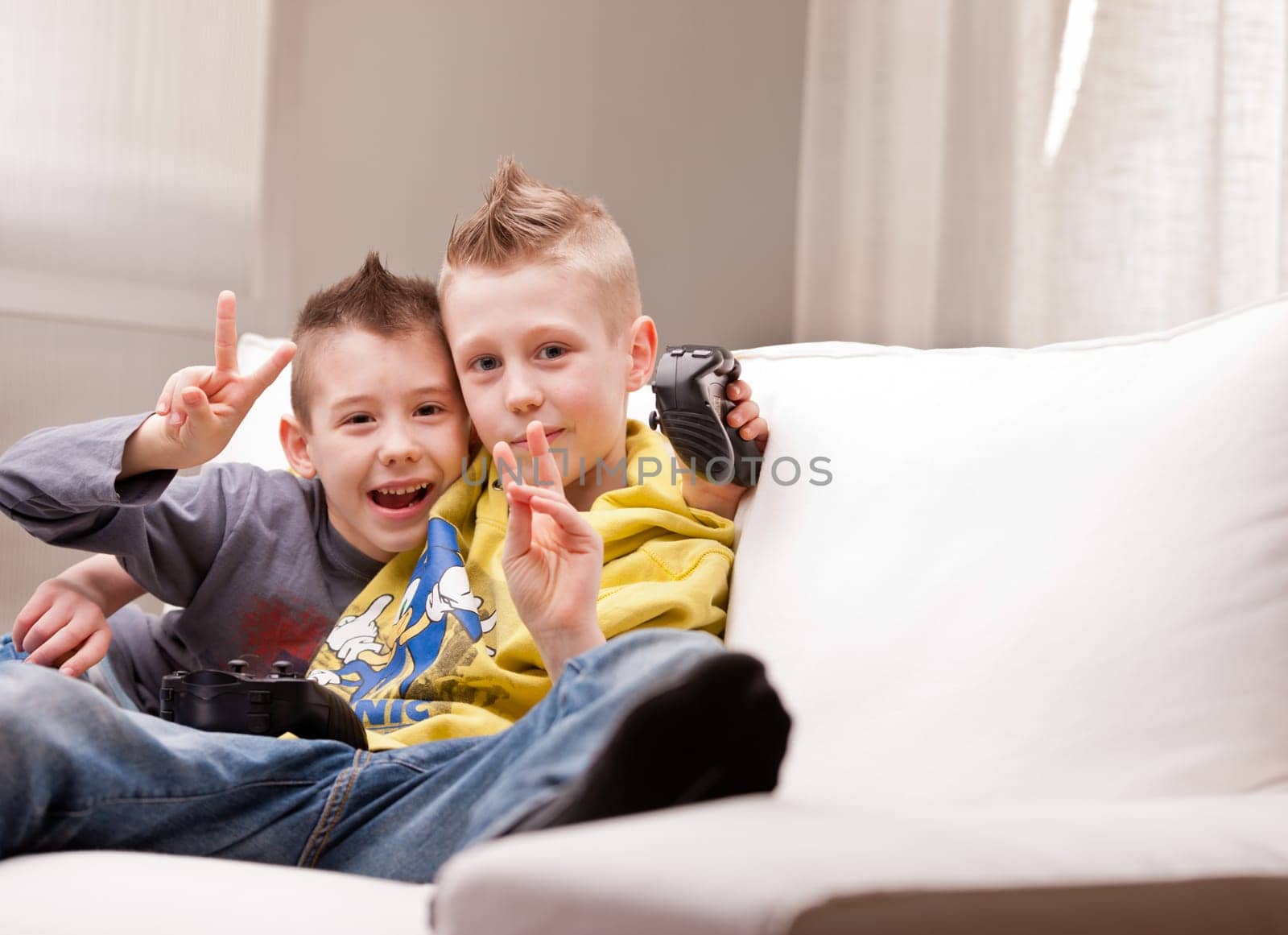 two little boys having lots of fun with video games