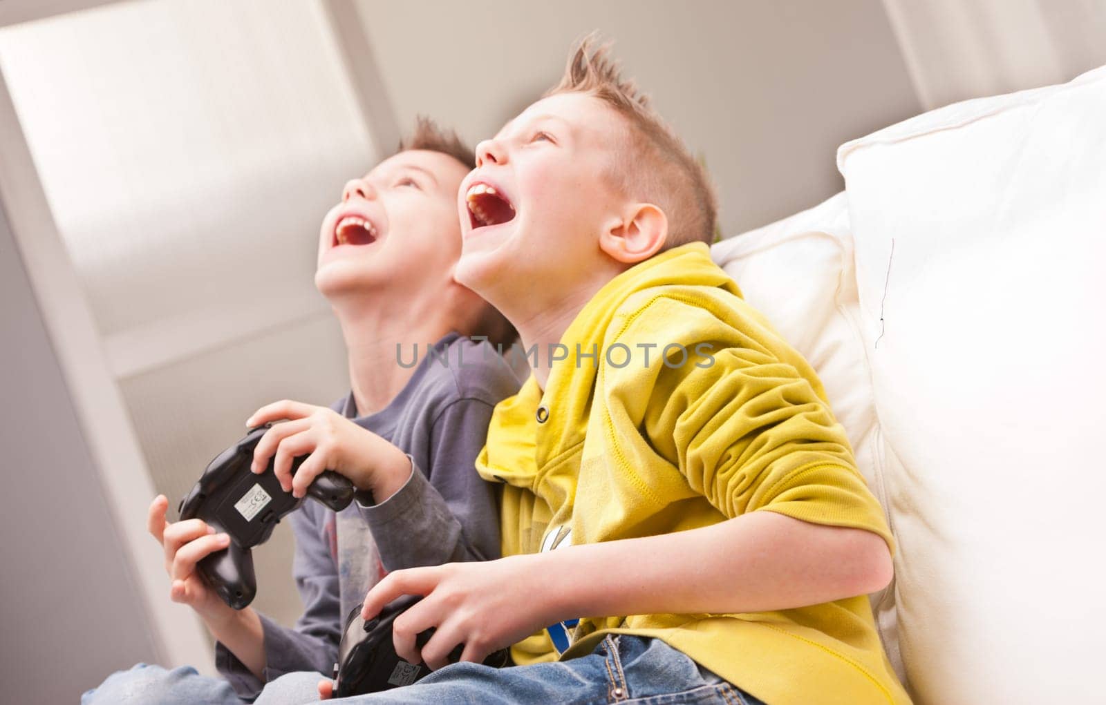 two little boys having lots of fun with video games