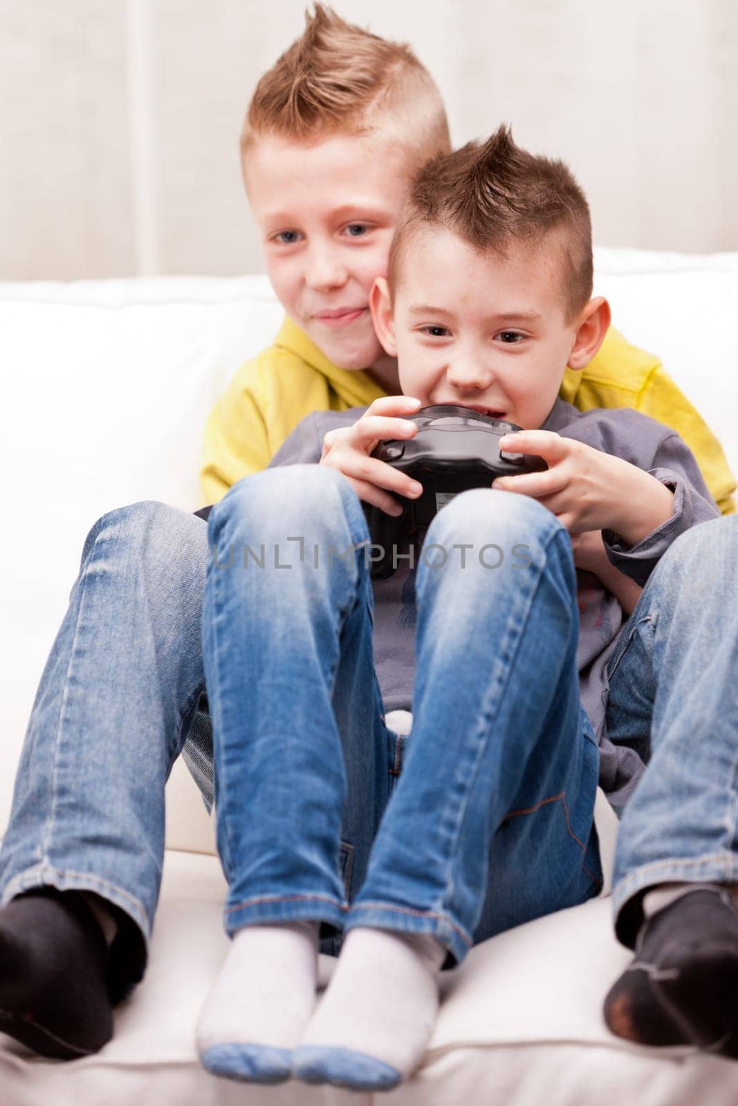 two little boys having lots of fun with video games