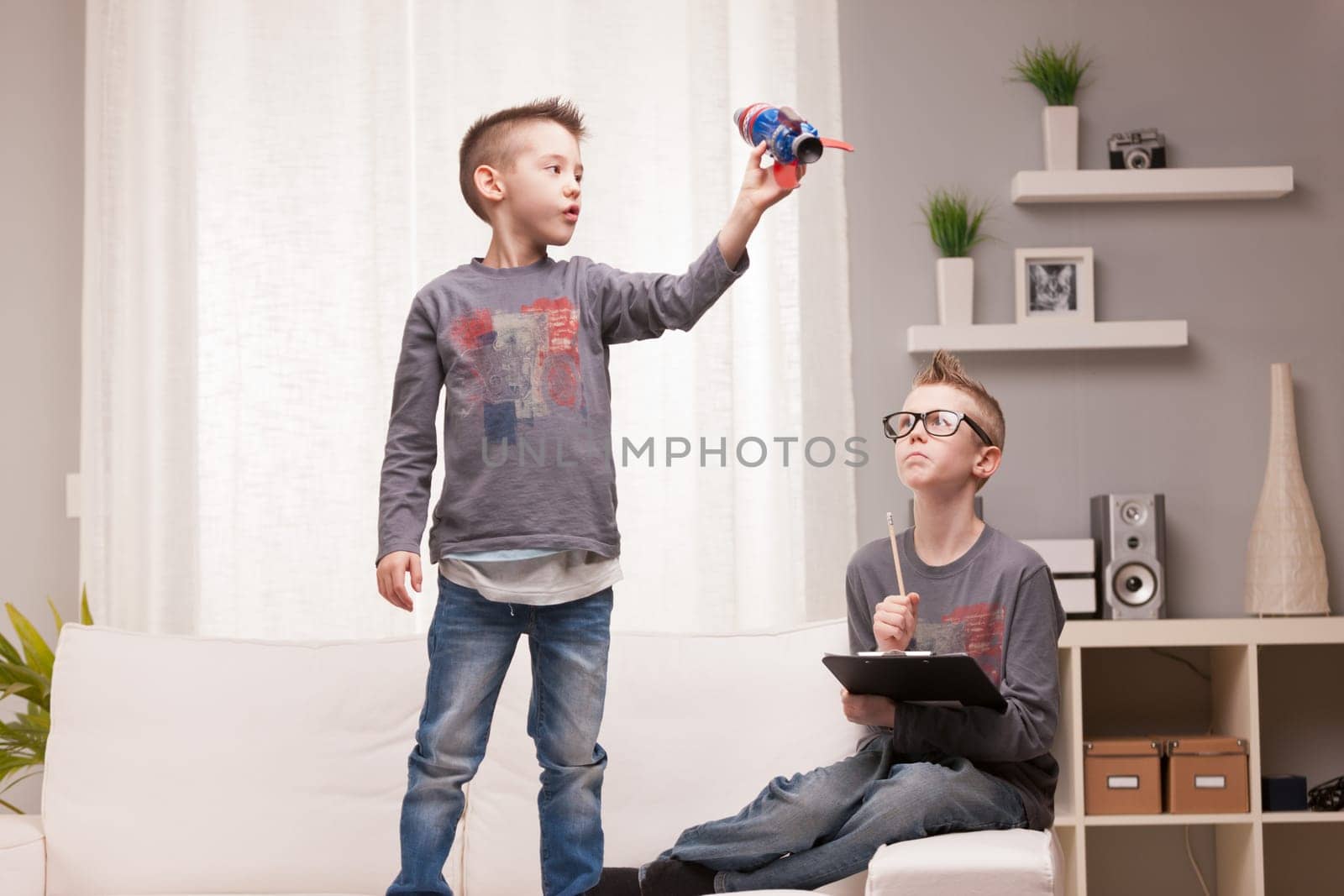 two boys playng as scientists and rocket inventors