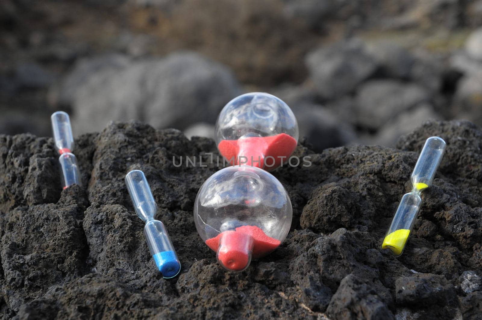 Time Concept - Hourglass Abandoned on the Volcanic Rocks
