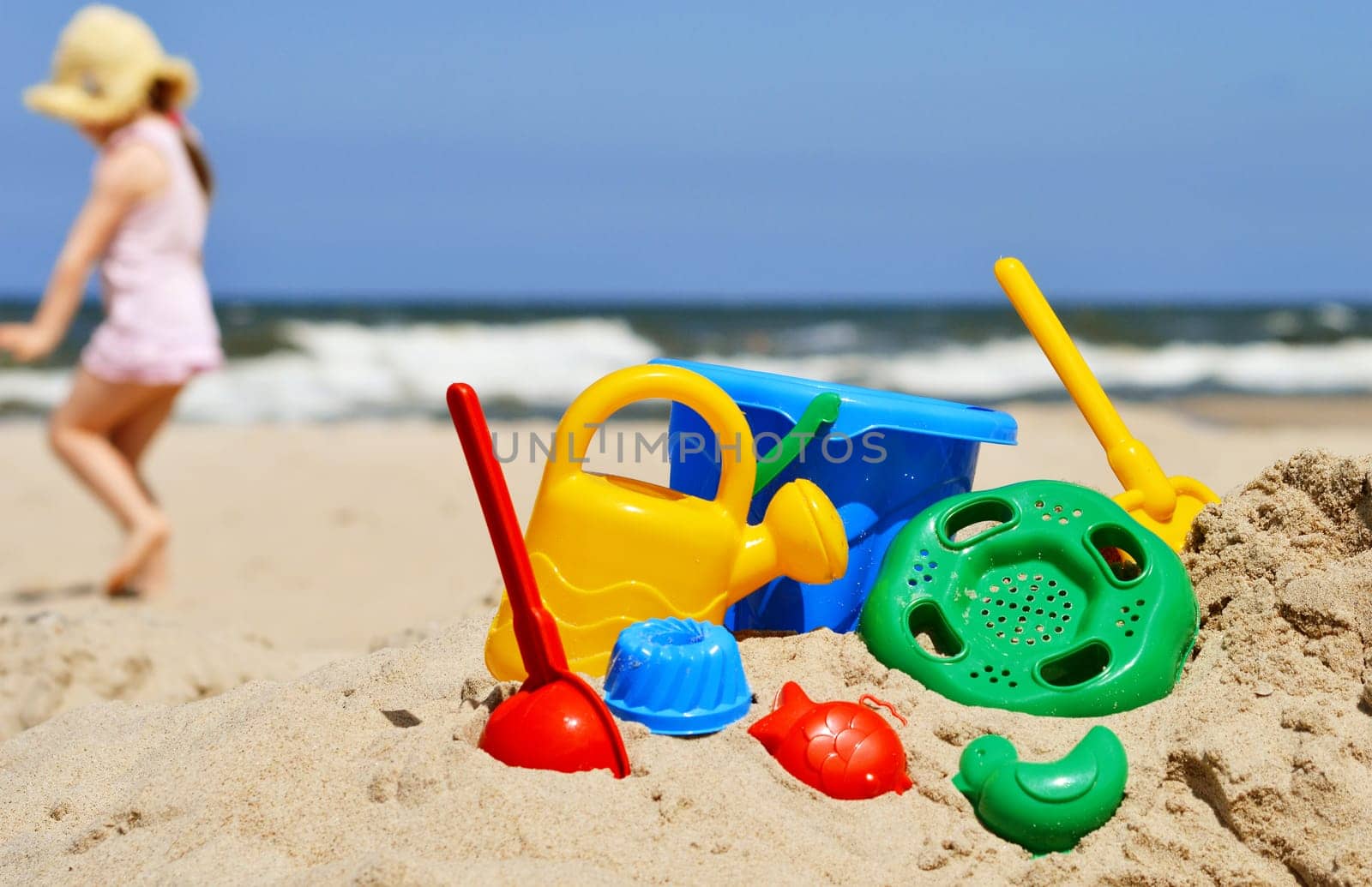 Plastic children toys on the sand beach