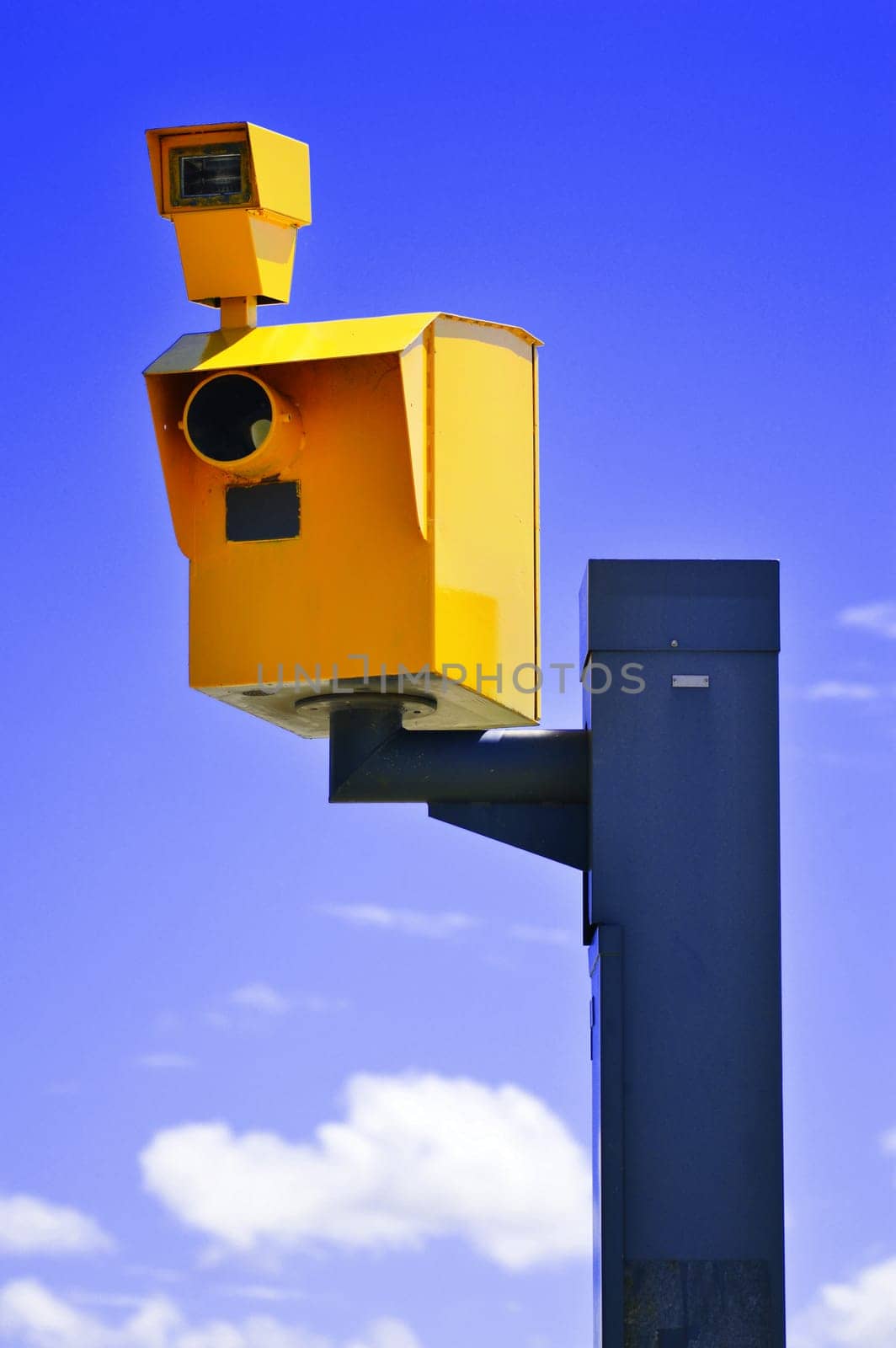 Traffic speed camera over the blue sky.